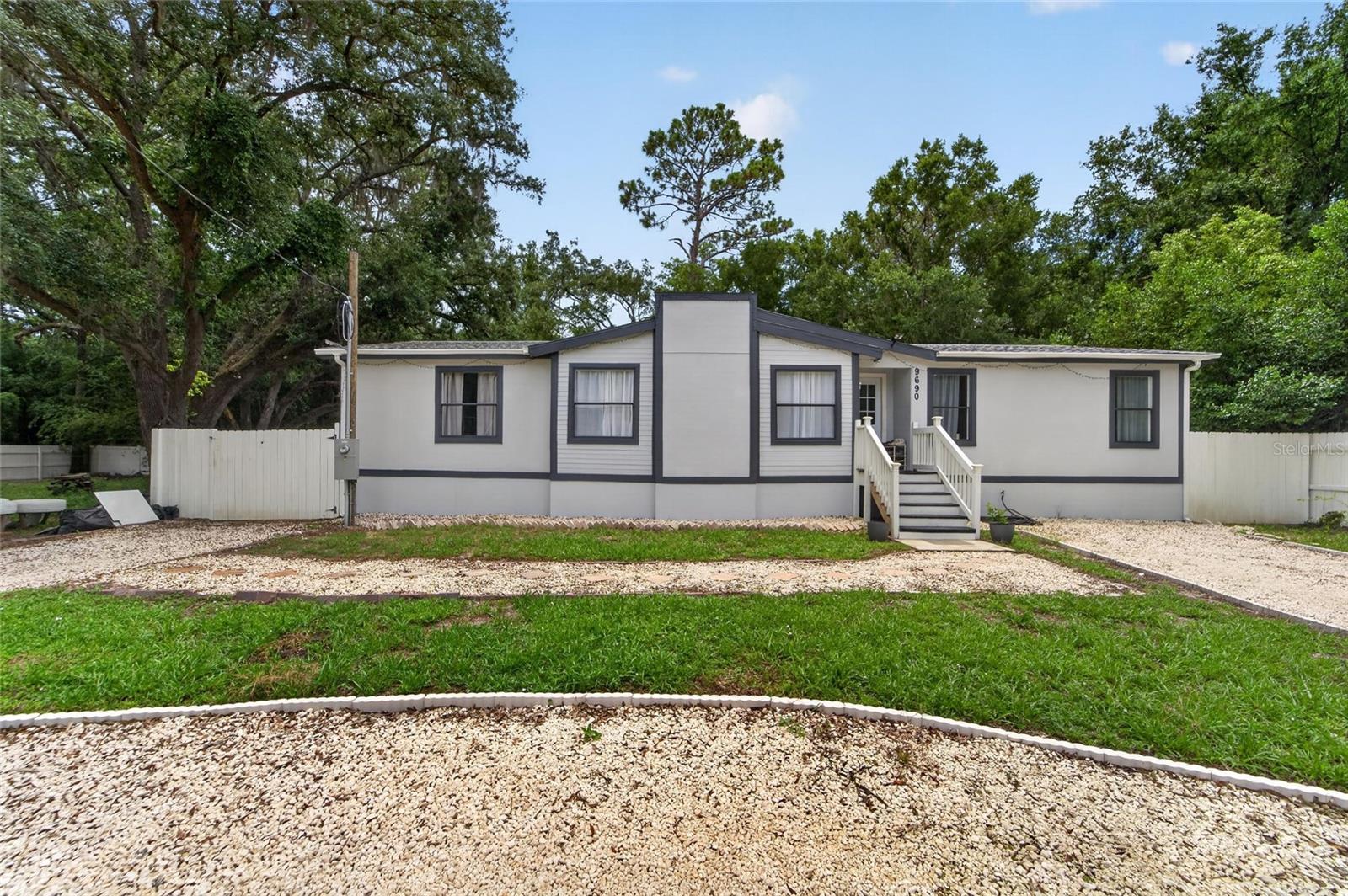 Discover the perfect blend of comfort, flexibility, and future potential with this beautifully remodeled 3-bedroom, 2-bathroom manufactured home in the heart of New Port Richey. Move-in ready and thoughtfully updated, this property offers an exceptional opportunity for homeowners, investors, or anyone looking for room to grow.
What truly sets this property apart is the adjacent vacant lot, owned by the same seller, which is available for purchase separately or together with the home. Create an oversized homesite, build additional outdoor living space, store your RV or boat, add a workshop, or simply enjoy the privacy and extra room that is increasingly difficult to find.
Inside, you'll love the bright open floor plan filled with natural light. The modern kitchen features ample cabinetry, generous counter space, and a breakfast bar that opens seamlessly to the dining area, creating the perfect layout for everyday living and entertaining. The split-bedroom design offers privacy, with a spacious primary suite featuring dual vanities, a walk-in shower, soaking tub, and abundant storage.
Step outside to a peaceful backyard surrounded by mature trees, offering the perfect setting for weekend barbecues, family gatherings, gardening, or simply relaxing while enjoying Florida's beautiful weather.
Conveniently located just minutes from the Ridge Road Extension and Suncoast Parkway, you'll enjoy quick access to Tampa, shopping, restaurants, medical facilities, schools, and the Gulf Coast's beautiful beaches. Outdoor enthusiasts will appreciate nearby Moon Lake Park, offering fishing, kayaking, picnic areas, basketball courts, playgrounds, and scenic walking trails.
NO HOA. NO FLOOD INSURANCE REQUIRED. Whether you're searching for your primary residence, a seasonal retreat, or an investment opportunity, this property delivers outstanding value with room for future possibilities.