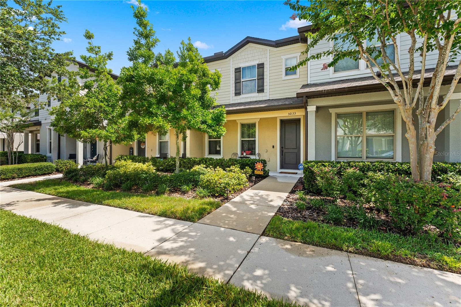 Welcome to 5033 Caspian St - A beautifully maintained townhome located in the highly sought-after Lakeshore at Narcoossee gated community just south of the booming Lake Nona area! Built in 2019, this move-in ready residence offers an open-concept floor plan designed for comfortable everyday living and effortless entertaining. The spacious living and dining areas flow seamlessly into a beautifully appointed kitchen featuring granite countertops, espresso cabinetry, and a large center island, creating a bright and inviting space for entertaining. Just off the kitchen, a private nook provides the perfect work-from-home area and opens to an expansive private courtyard, ideal for grilling, relaxing, and enjoying the Florida lifestyle. Upstairs, you’ll find two generously sized bedrooms, including an expansive primary suite with a well-appointed bath featuring a double vanity, glass-enclosed walk-in shower, and large walk-in closet.   Enjoy low-maintenance living with access to exceptional community amenities, including a gated entrance, resort-style pool, fitness center, dog park, playground, community dock, and access to Fells Cove and East Lake Tohopekaliga. Ideally located near top-rated schools, Lake Nona Medical City, Orlando International Airport, major highways, shopping, dining, and entertainment, this townhome offers the perfect blend of comfort, convenience, and Florida lifestyle living. Whether you’re a first-time homebuyer, investor, or looking to downsize, this property is an outstanding opportunity in one of the area’s most desirable communities. Call today for a private tour!
