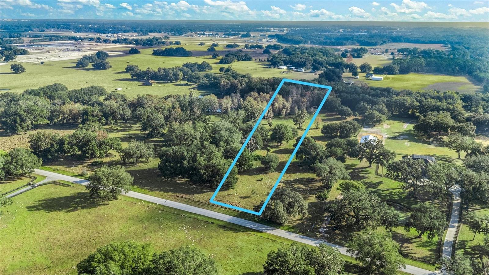 Discover the ideal balance of privacy, natural charm, and convenience with this remarkable 6.31-acre property in Wildwood. Surrounded by majestic oak and hickory trees, the land features rolling terrain with elevations ranging from 55 to 95 feet, offering both seclusion and the opportunity for creative landscaping. Approximately 2.53 acres are located within Flood Zone A, providing flexibility for development and thoughtful planning. Tucked away on a peaceful side street, this property offers a serene rural setting while remaining close to essential amenities. Major routes like US 301, I-75, SR 44, and the Florida Turnpike are just minutes away, making travel effortless. The Twisted Oaks mixed-use development, located less than 1.5 miles away, will add dining and retail options to the area. Downtown Wildwood is only 2 miles away, and The Villages, just to the east, offers a wide range of shopping, dining, and entertainment. Smaller parcels like this (under 10 acres) are increasingly hard to find. Two additional parcels are also available (G5107952 & G5090335)—get in touch for more details!