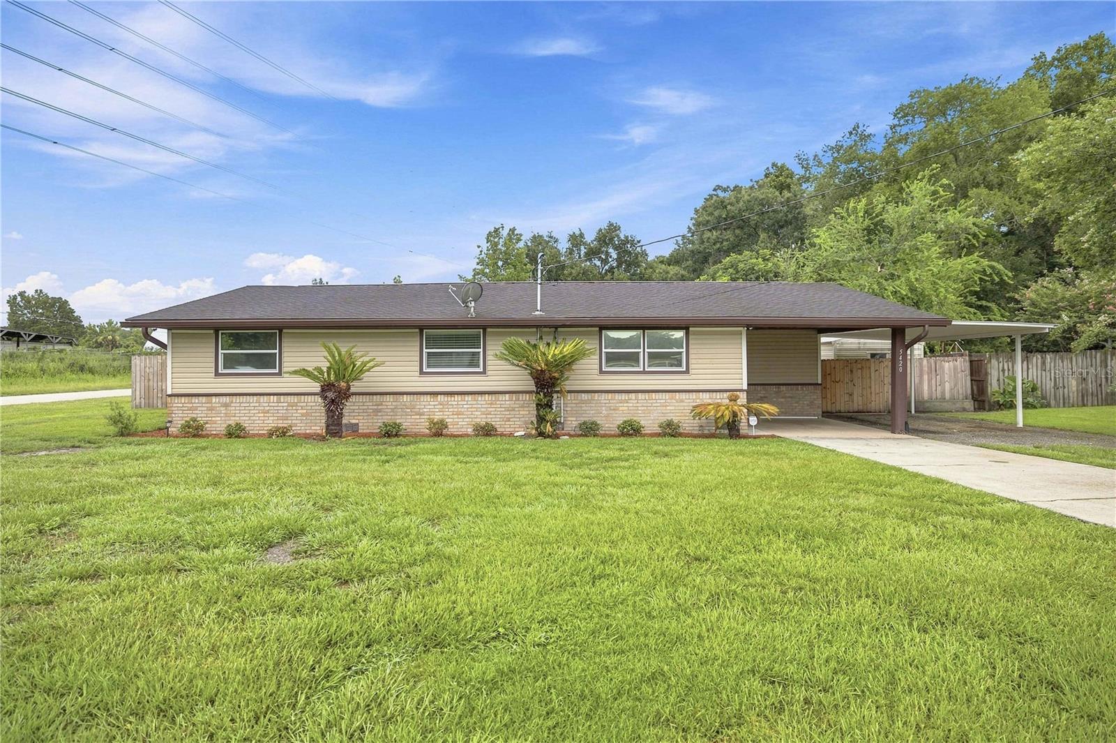 Beautifully remodeled and move-in ready, this 4-bedroom, 2-bath home is situated on a desirable corner lot and offers a functional layout with thoughtful updates throughout. Originally built in 1981, the home has been tastefully renovated to provide modern comfort while maintaining its charm. Roof 2015. The spacious primary suite features a beautifully updated ensuite bathroom with a walk-in shower and convenient washer and dryer hookups. Laminate flooring extends throughout all bedrooms, while the bathrooms are finished with durable tile flooring for easy maintenance. Each bedroom includes built-in closet organizers, providing excellent storage and organization. Step outside to enjoy the fully fenced backyard, offering privacy and plenty of space for outdoor living, pets, or entertaining. Covered parking is abundant with both a front carport and an additional rear carport, providing flexibility for multiple vehicles, boats, or recreational equipment. Conveniently located on a corner lot with easy access to shopping, dining, schools, and major roadways, this turnkey home is ready for its next owner. Schedule your private showing today!