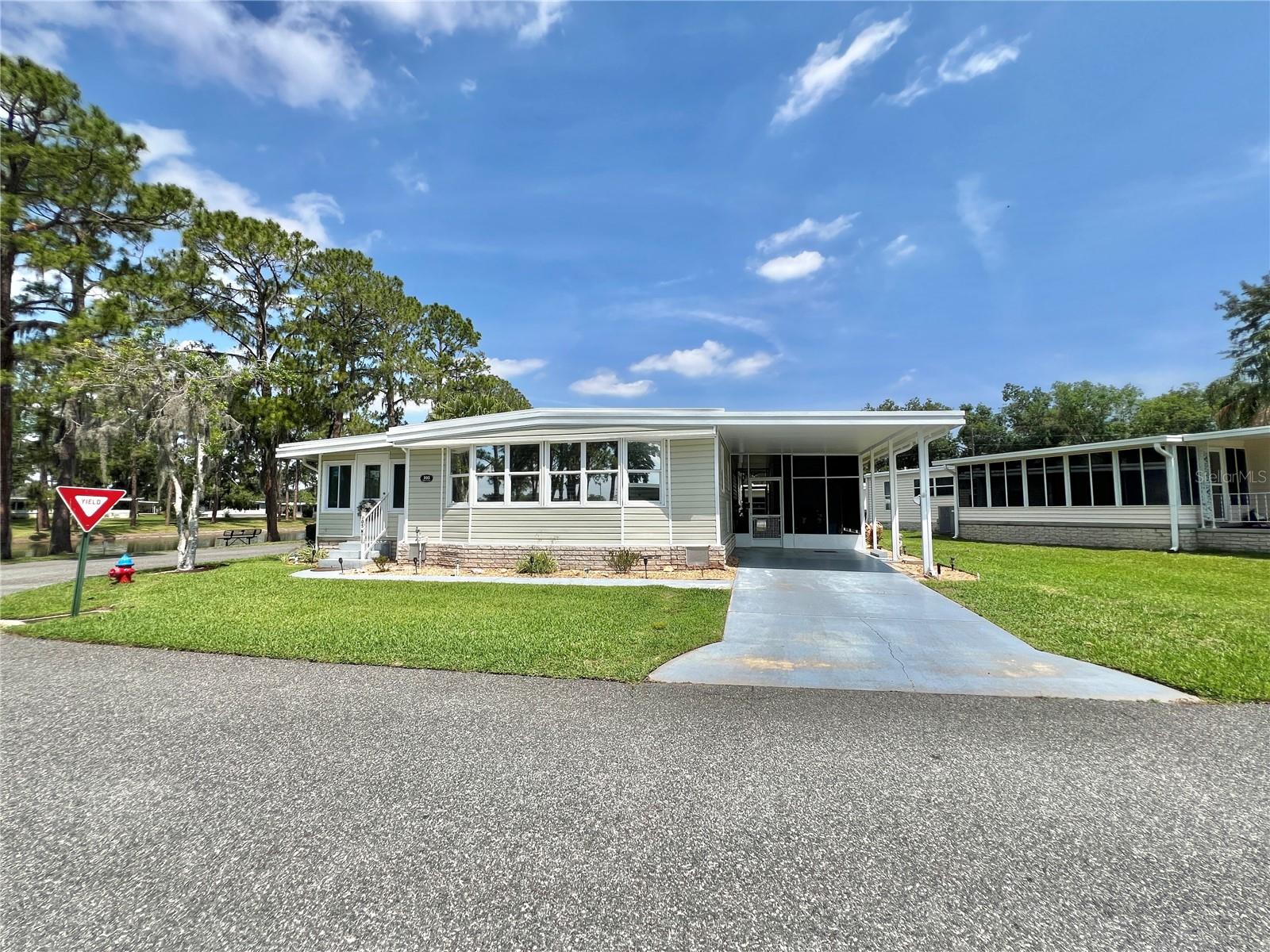Wake up to peaceful sunrises over Lake Serenity in this beautifully updated, fully furnished turnkey home, where every detail has been thoughtfully designed for effortless Florida living. Complete with a bonus golf cart, this home is ready for you to arrive, unpack, and start making memories. Inside, the bright, open living space is filled with natural light and features new luxury vinyl plank flooring, fresh interior paint, and a welcoming flow that instantly feels like home. The enclosed Florida room is the heart of the home, offering uninterrupted lake views and a quiet place to sip your morning coffee, read a book, or simply watch the water shimmer at sunset. The renovated kitchen blends warmth and style with custom butcher block countertops, updated cabinetry and hardware, stainless steel appliances, and a breakfast bar that keeps everyone connected whether you’re hosting friends or enjoying a quiet evening in. The bathrooms have been beautifully refreshed with custom butcher block countertops, contemporary vanities, updated fixtures, and a sleek glass-enclosed walk-in shower in the primary suite. Spacious bedrooms have generous closet space, while updated lighting, ceiling fans, and modern finishes add to the home’s fresh, inviting feel. Fully furnished and turnkey, this home takes the stress out of moving so you can focus on enjoying the lifestyle you’ve been dreaming of. Hop in the included golf cart and explore the neighborhood, meet friends, or head to the community amenities with ease. If you’ve been searching for more than just a house, a place where every day feels a little more relaxed and every window frames a beautiful view, this Lake Serenity home is waiting for you................Hawthorne at Leesburg is an active, resident owned, 55+ cooperative, waterfront, gated community, with beautifully landscaped grounds, lakes with illuminated fountains and a relaxing and comfortable gazebo. The affordable monthly maintenance fee of $346 includes water, sewer, lawn mowing, private emergency services and storage space for recreational vehicles, boats, trailers and much more! The beautiful clubhouse is complete with a full-time program coordinator, more than 100 different activities and seating for 550. It has a hospitality lounge, card rooms, craft rooms, billiard room, fitness center, library, fine arts room and many more. There is excellent fishing, outdoor geo-thermally heated pool and two enclosed therapeutic pools. Hawthorne boasts a private marina monitored by an electronic security system with over 120 boat slips and access to the Harris Chain of Lakes and beyond.