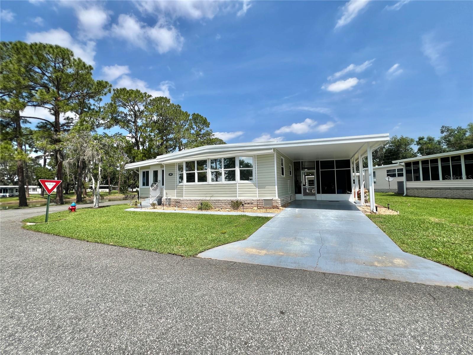 Wake up to peaceful sunrises over Lake Serenity in this beautifully updated, fully furnished turnkey home, where every detail has been thoughtfully designed for effortless Florida living. Complete with a bonus golf cart, this home is ready for you to arrive, unpack, and start making memories. Inside, the bright, open living space is filled with natural light and features new luxury vinyl plank flooring, fresh interior paint, and a welcoming flow that instantly feels like home. The enclosed Florida room is the heart of the home, offering uninterrupted lake views and a quiet place to sip your morning coffee, read a book, or simply watch the water shimmer at sunset. The renovated kitchen blends warmth and style with custom butcher block countertops, updated cabinetry and hardware, stainless steel appliances, and a breakfast bar that keeps everyone connected whether you’re hosting friends or enjoying a quiet evening in. The bathrooms have been beautifully refreshed with custom butcher block countertops, contemporary vanities, updated fixtures, and a sleek glass-enclosed walk-in shower in the primary suite. Spacious bedrooms have generous closet space, while updated lighting, ceiling fans, and modern finishes add to the home’s fresh, inviting feel. Fully furnished and turnkey, this home takes the stress out of moving so you can focus on enjoying the lifestyle you’ve been dreaming of. Hop in the included golf cart and explore the neighborhood, meet friends, or head to the community amenities with ease. If you’ve been searching for more than just a house, a place where every day feels a little more relaxed and every window frames a beautiful view, this Lake Serenity home is waiting for you................Hawthorne at Leesburg is an active, resident owned, 55+ cooperative, waterfront, gated community, with beautifully landscaped grounds, lakes with illuminated fountains and a relaxing and comfortable gazebo. The affordable monthly maintenance fee of $397 includes water, sewer, lawn mowing, private emergency services and storage space for recreational vehicles, boats, trailers and much more! The beautiful clubhouse is complete with a full-time program coordinator, more than 100 different activities and seating for 550. It has a hospitality lounge, card rooms, craft rooms, billiard room, fitness center, library, fine arts room and many more. There is excellent fishing, outdoor geo-thermally heated pool and two enclosed therapeutic pools. Hawthorne boasts a private marina monitored by an electronic security system with over 120 boat slips and access to the Harris Chain of Lakes and beyond.
