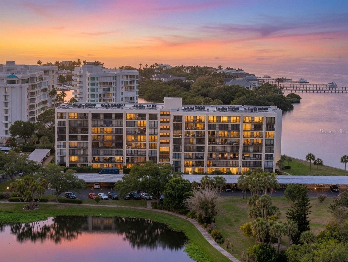 Wake up to peaceful pond views with partial views of the Intracoastal Waterway from this beautifully updated second-floor residence, tucked behind the gates of the Belleair Country Club in the highly desirable Bayshore I community. Combining contemporary finishes with the privacy, security, and convenience that make Belleair so desirable, this inviting condominium offers a relaxed coastal lifestyle just minutes from the Gulf beaches.  Inside, abundant natural light fills the thoughtfully updated interior, where clean lines and contemporary finishes create a warm, inviting atmosphere. The beautifully appointed kitchen serves as the centerpiece of the home, featuring a spacious center island with seating for three, making it the perfect place for casual meals, morning coffee, or gathering with family and friends.  Sliding glass doors open to a generous 26-foot balcony where you can enjoy peaceful pond views, partial views of the Intracoastal Waterway, gentle coastal breezes, and colorful sunsets.  Residents of Bayshore I enjoy the convenience of elevator access, beautifully maintained grounds, a heated community pool, secure building entry, abundant guest parking, and the peace of mind provided by a 24-hour staffed guard gate. Located within the Belleair Country Club community, owners have the opportunity to apply for social or golf membership and enjoy one of Florida's most historic private clubs, offering championship golf, exceptional dining, a state-of-the-art fitness center, tennis, pickleball, croquet, and an active social calendar.  Conveniently located just minutes from boutique shopping, fine dining, Morton Plant Hospital, the Belleview Inn, and the world-famous Gulf beaches, this beautifully updated residence offers an exceptional opportunity to enjoy one of Belleair's most sought-after gated communities.  Move right in, unpack, and experience a lifestyle where security, convenience, and timeless Belleair charm come together in one exceptional location.