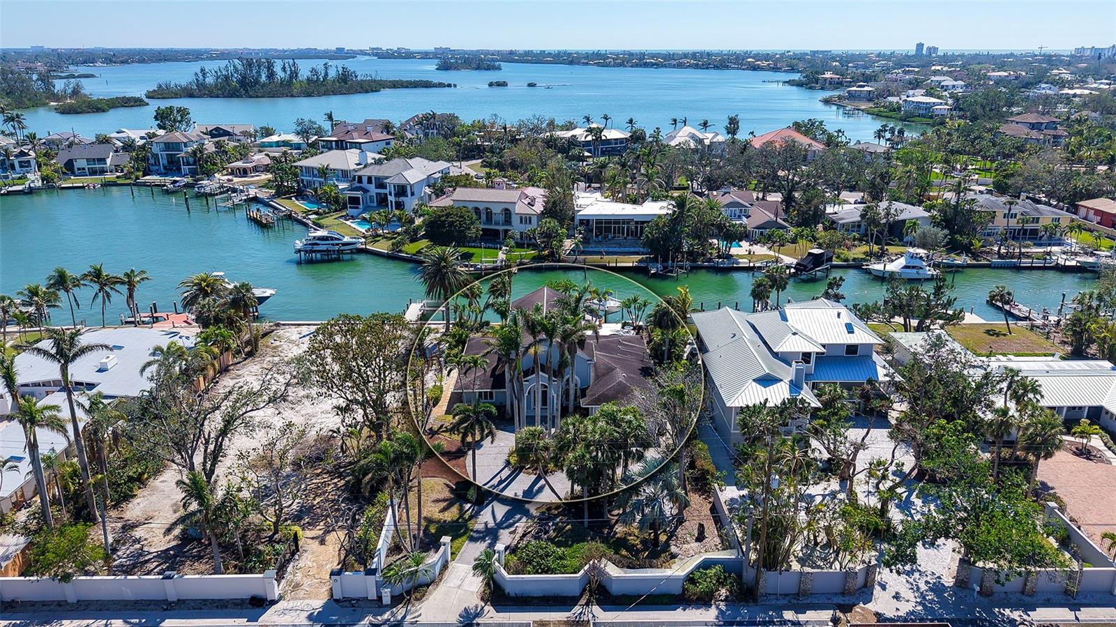 Rare and extraordinary waterfront offering on the coveted North end of Siesta Key, this premier Bay Island estate parcel presents the ultimate canvas for creating a world-class coastal retreat. Set on nearly half an acre, the property commands sweeping waterway views and offers 90 feet of protected sailboat-water frontage, complete with an existing 73-foot composite and tile dock—an exceptional amenity for the discerning boating enthusiast.
To seamlessly bring your vision to life, fully customizable luxury home plans, as well as projected expenditure framework are available for review from Salt Wave Construction thus significantly expediting the design-build process. The seller has also committed to demolition of the existing structure, allowing for a smooth and efficient transition to new construction.
The proposed residence spans approximately 6,366 square feet, including over 4,000 square feet of refined, air-conditioned living space, thoughtfully designed to maximize waterfront exposure and elevate indoor-outdoor living. Multiple entertaining spaces, expansive terraces, and view-oriented decks create the perfect setting for both grand gatherings and intimate moments, all framed by captivating water vistas.
Ideally located for effortless access on and off Siesta Key and just minutes from the culture, dining, and sophistication of Downtown Sarasota, this exceptional property offers the rare combination of privacy, prestige, and proximity. An unparalleled opportunity to craft a legacy waterfront estate in one of Sarasota’s most sought-after enclaves.