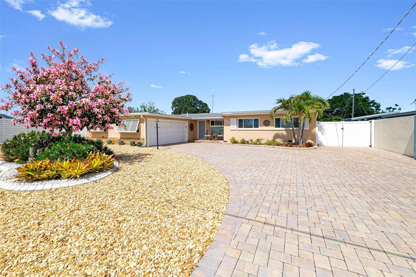 The best kept secret in Bradenton! A house on an island surrounded by a deep, saltwater canal that leads out into Sarasota Bay and beyond. Picture jumping into your boat cradled by a 10,000 lb. lift - with a cover - and heading out to restaurants or sandbars or fishing. When you get home, jump into your solar heated pool and relax. On a rainy day, you can tinker in your workshop and get your creative juices flowing. This home is on a cul de sac making it an extra-large lot with plenty of waterfront and an over 180-degree view. There is room for a second boat, kayak or jet ski lift. Consider the things that most wouldn’t notice, hurricane windows throughout the house, new and updated electrical panels, a refinished seawall cap and extra storage inside and in the garage. This is a home that makes you feel as though you are always on vacation! Showings by appointment only.