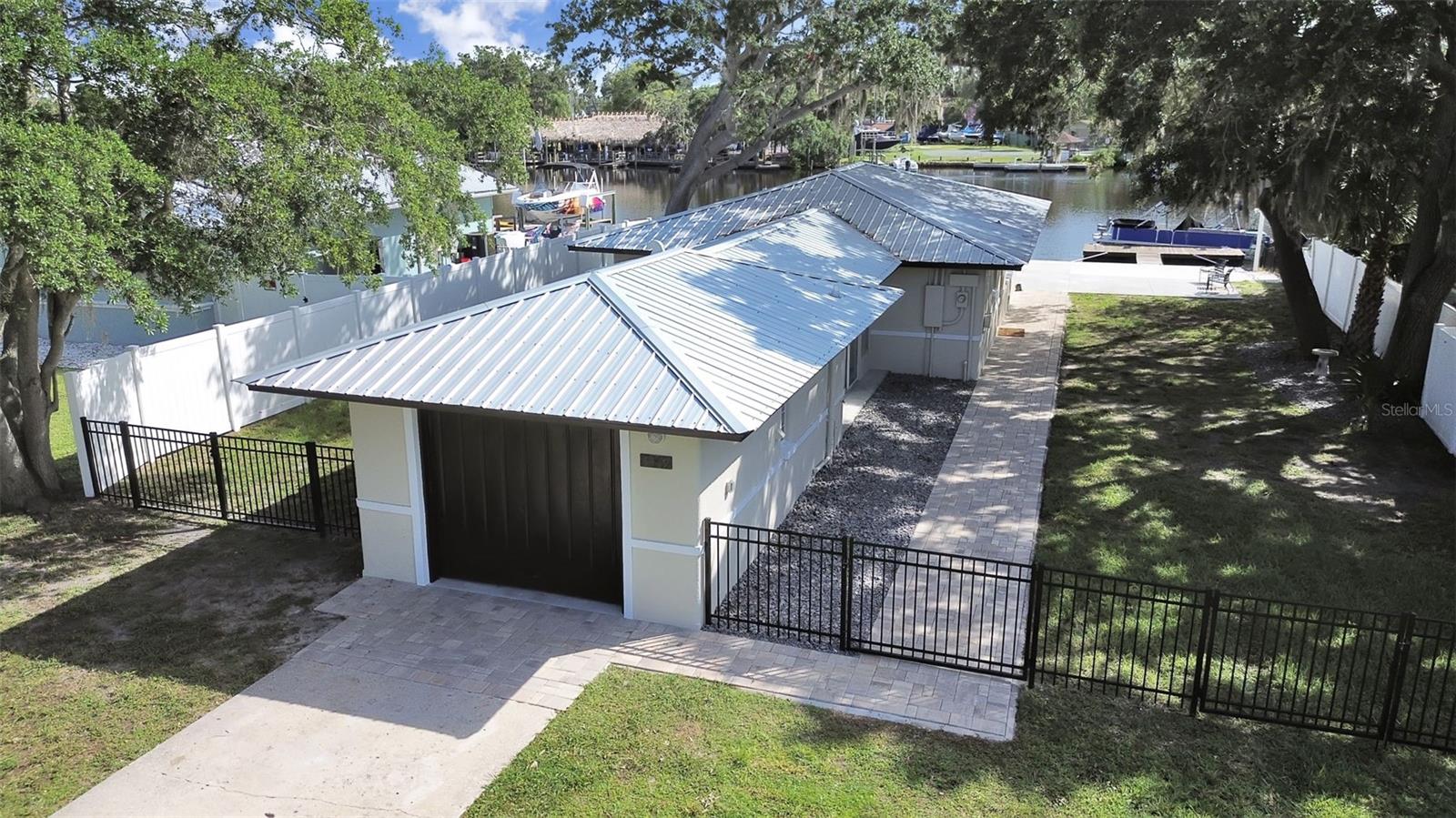 COTEE RIVER WATERFRONT: Gulf Access · 65-Ft. Frontage · Boat Dock & Lift — No HOA! Wake up to 65 feet of direct Cotee River frontage and a private floating dock and boat lift just steps from your door. Head west to open Gulf waters for fishing and scalloping in minutes, or head east by boat into vibrant downtown New Port Richey — restaurants, breweries, and live concerts at Sims Park. This stunning, fully renovated 3/2, 1,621 sq. ft. home sits on a private lot with NO HOA and NO CDD. THE LIFESTYLE: Sixty-five linear feet of direct Gulf-access riverfront is rare inventory on the Cotee at any price. Your dock is ready for Sunday fishing runs and sunset cruises alike. A brand-new seawall and pavered back patio complete the picture. FULLY RENOVATED — MOVE-IN READY: All the major work is done. NEW Roof (2024), NEW HVAC (2024) with manufacturer's warranty through 2034, NEW Water Heater (2024), NEW Seawall (2025). Inside: tile floors throughout, a freshly updated master bath, and a renovated kitchen with new countertops and stainless steel appliances. Built tough with flood-resilient construction throughout. Minutes from Morton Plant North Bay Hospital, Gulf High School, Sims Park, and the Suncoast Parkway for an easy Tampa commute. Waterfront on the Cotee River doesn't wait. Schedule your private showing today.