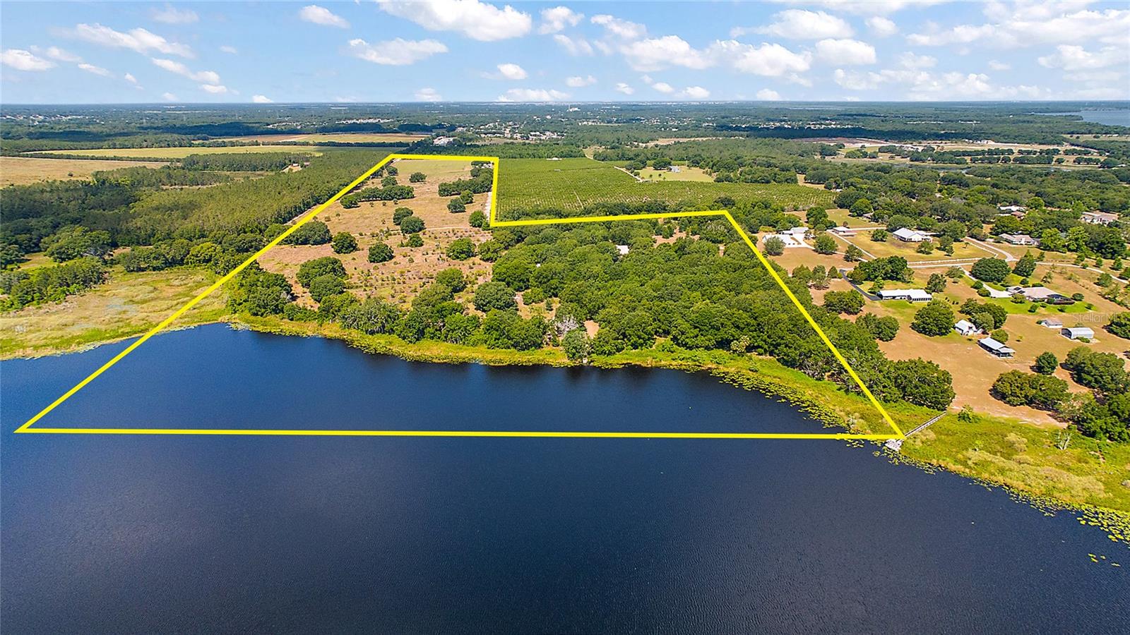 Opportunity - 80+/- Acres on spring fed 45 acre lake with 1,500+/- of private lake frontage with dock. Property is an assemblage of 7 parcels. Located in Howey in the Hills and less than an hour to Orlando, Ocala or The Villages. Property has a stunning 5,533+/- SF estate home built in 2005 with 6/3/2, inground pool and attached 3 car garage. Value is in the land. Property is shown by appointment only and home may be seen with proof of funds & executed Confidentially Agreement. Property has a large 50'x75'x16 metal workshop building with 3 grade level 12'x12' roll up doors. Finally there is an additional 1,232+/-SF  mobile home residence on the property.  DO NOT ENTER WITHOUT LISTING AGENT - entry without an appointment is trespassing. This beautiful Central Florida property would be great for a family or investment or both.