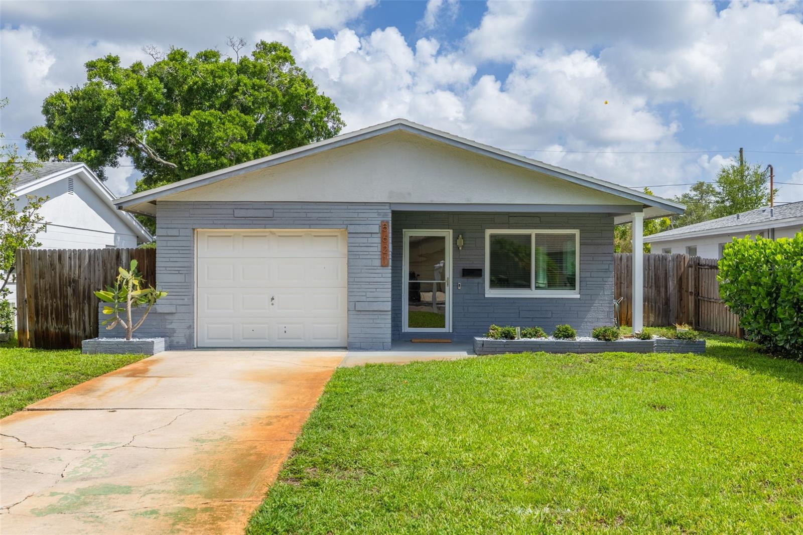 **ATTENTION FIRST-TIME HOME BUYERS & STARTER HOME SHOPPERS** Welcome home to this charming, solid block construction property at 5621 16th Ave N! This 2-bedroom, 1-bath home with a 1-car garage is located in the desirable Flood Zone X, which typically means flood insurance is not required, offering peace of mind from day one. Enjoy a stress-free start to homeownership with major systems already updated: The home features a 2017 HVAC and Electrical Panel, 2019 Roof, 2021 Hurricane-Rated Windows and Front Door, and a NEW 2026 Water Heater. Cosmetic updates include all BRAND NEW interior paint and NEW interior doors! The interior boasts a light and bright open living and dining area and an adorable kitchen complete with a charming window over the sink. Relax in the lovely Florida Room which provides a perfect view overlooking the spacious backyard. Outdoor living is a dream with a fully fenced, pool-sized backyard that offers convenient alley access. This home is truly move-in ready and perfectly situated near local favorites like Publix or Aldi, and recreational spots such as Tyrone Park and JW Cate. Don't miss this opportunity to start your homeownership journey