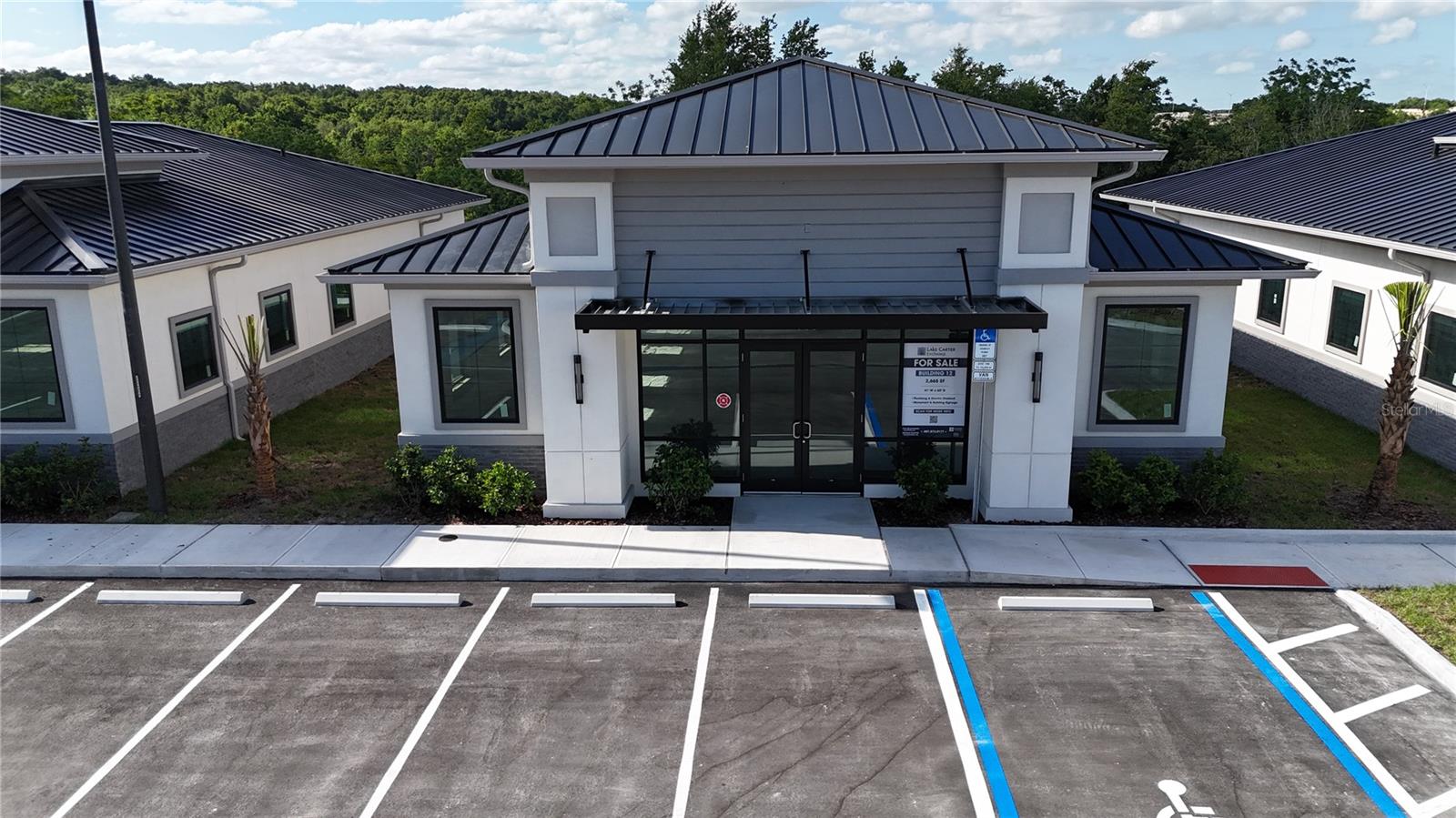 Building #12 is available for purchase at Lake Carter Exchange, a distinguished mixed-use development in Apopka’s East Shore at the intersection of Ocoee-Apopka Road and W Keene Road. This dark gray shell building is ideal for medical or professional offices, with potential for retail use based on buyer needs. The shell delivery offers full flexibility for custom interior design. The development is strategically located less than one mile from Advent Health’s seven-story, 120-bed hospital and opposite a new Publix Supermarket development. Situated in the vibrant East Shore trade area, which includes 5,000 planned residences and an average household income above $100k, this Class A property is perfectly positioned for businesses targeting growth in Central Florida’s second-fastest-growing city. Contact us for pricing details/incentives and to schedule a tour of this exceptional commercial opportunity.