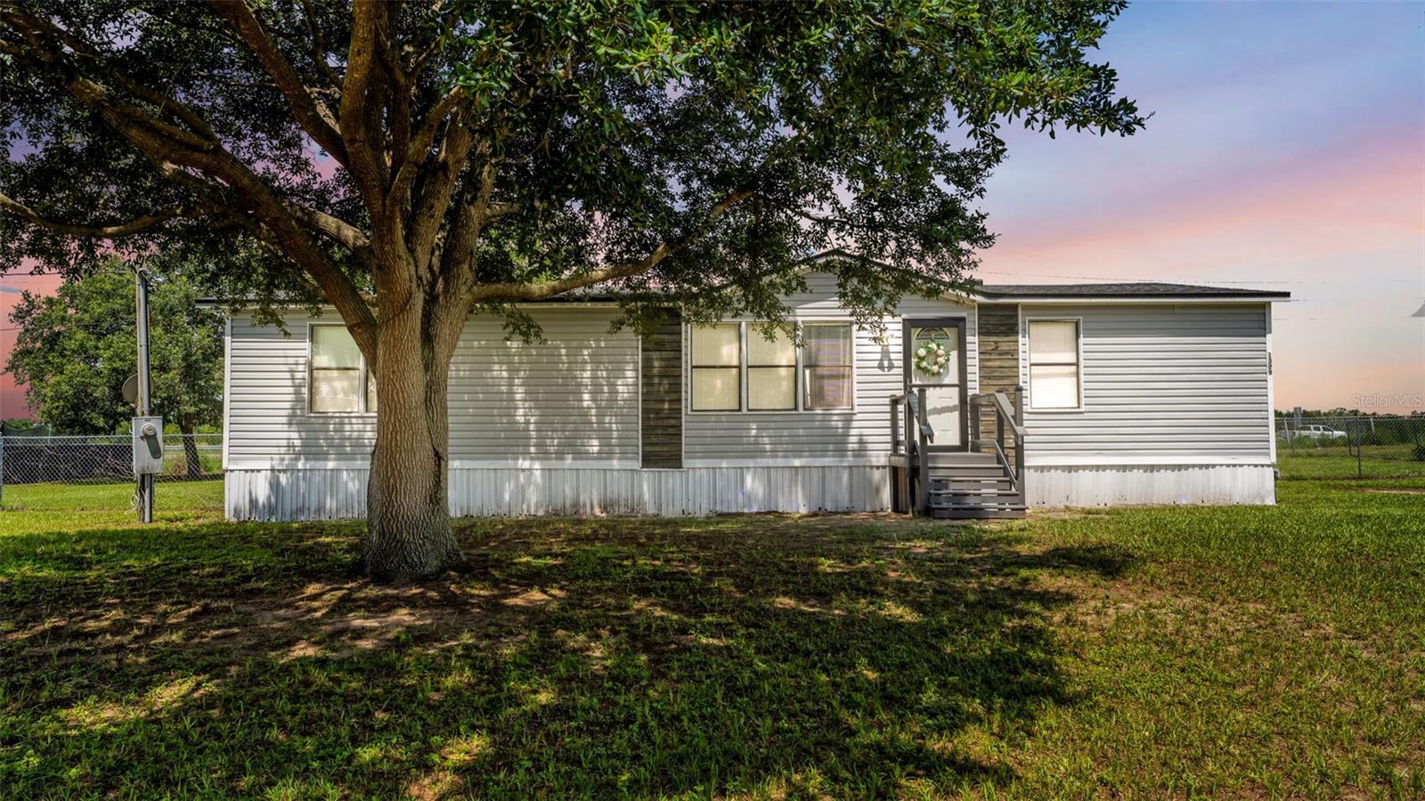 USDA financing may be available for qualified buyers, potentially allowing 100% financing with no down payment. Welcome to country living! Situated on .5 acres, this well-maintained 3-bedroom, 2-bath home offers both privacy and room to spread out. Recent updates include a newer roof, newer AC unit, and newer well pump, giving buyers extra peace of mind. Inside you will find living and entertaining spaces designed for comfort. The oversized fenced lot provides space for gardening, storing recreational vehicles or relaxing with the family while watching a gorgeous sunset. A 12x14 shed with power is perfect for a workshop or hobby space. Enjoy the Florida lifestyle while living near the Van Fleet trail as well as Lake Myrtle Sports complex. Make sure you see this one today!