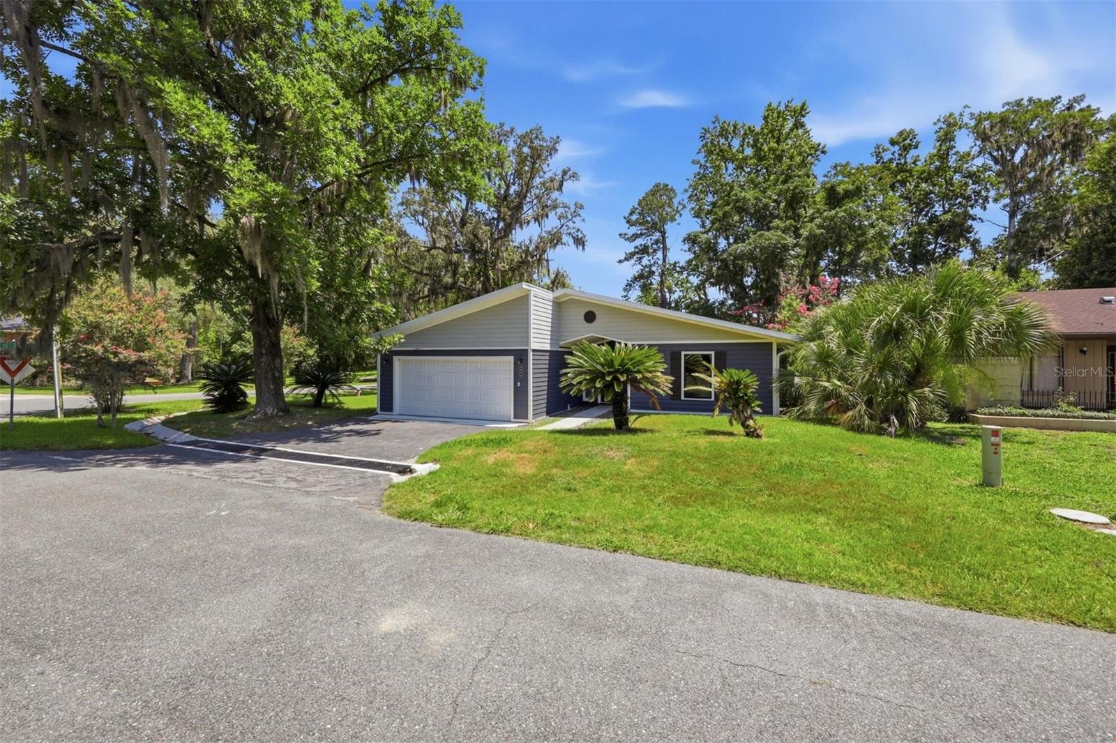 Thoughtfully renovated with custom touches, this move-in ready home in the gated golf course community of Turkey Creek waits for you! This 3-bedroom, 2-bath home offers 1,842 heated and cooled square feet plus a separate 208-square-foot heated and cooled sunroom, creating over 2,050 square feet of conditioned living space.
Step through the impressive front entry with decorative sidelights into a bright, open floor plan featuring luxury vinyl plank flooring throughout the main living areas, vaulted ceilings, a wood-burning fireplace, and abundant natural light including 2 skylights. The elegantly remodeled kitchen features new shaker style wood cabinetry with soft close doors and drawers, granite countertops, new stainless-steel appliances, subway tile backsplash, farmhouse sink, large center island, and an oversized walk-in pantry.
The split-bedroom floor plan provides privacy for the primary suite including a large walk-in closet. The completely remolded ensuite bath includes dual sinks with a new wall hung vanity, a large walk-in shower with a rain shower head. The remolded guest bathroom includes new wood cabinetry with updated plumbing fixtures and new tiled tub walls. This guest bath is conveniently between the guest bedrooms. Updated door hardware and finishes throughout give the home a fresh, modern feel.

Relax and enjoy your heated and cooled sunroom with views to your beautiful backyard. Or step out onto your covered wood deck for additional entertaining choices. Extra features include an interior utility room with washer and dryer, oversized 2-car garage with sealed floor, luxury vinyl plank flooring, corner lot location, and views across the street toward the 8th fairway.

Enjoy all that Turkey Creek has, including gated security, community pool, pickleball and tennis courts, playground, restaurant, golf course, and golf cart-friendly streets. Conveniently located near Gainesville, Alachua, I-75, shopping, dining, and medical facilities.

"Information deemed reliable but not guaranteed. Buyer and agent to verify all measurements, square footage, and property details."