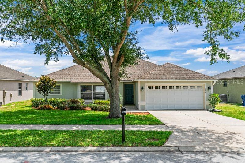 Located in the sought-after Lake Douglas/Westwood community in Groveland, this beautifully maintained single-family home offers 4 bedrooms, 2 full bathrooms, and just under 1,700 square feet of comfortable living space. The open floor plan creates a seamless flow throughout the home, complemented by tile and laminate flooring throughout for easy maintenance and style. The kitchen features a center island, breakfast bar, stainless steel range (only 4 months old), dishwasher (new), microwave, and refrigerator. Washer and dryer are also included. The spacious primary suite includes a garden tub, separate walk-in shower, dual sinks, and a walk-in closet. Sliding glass doors open to a covered lanai — the perfect spot to relax and unwind. Additional highlights include: Storage room in the back for added connvenience. Attached 2-car garage. Pride of ownership throughout. Home recently painted both inside and exterior. New duct work done in 2020 and AC was replaced in 2021. Ideally located less than a mile from Publix and other shopping, with major restaurants, box stores, hospital, Hwy 50, golf courses, lakes, and downtown Clermont (boat launch), farmers market  all within a 10-minute drive. Won't last! Excellent investment.