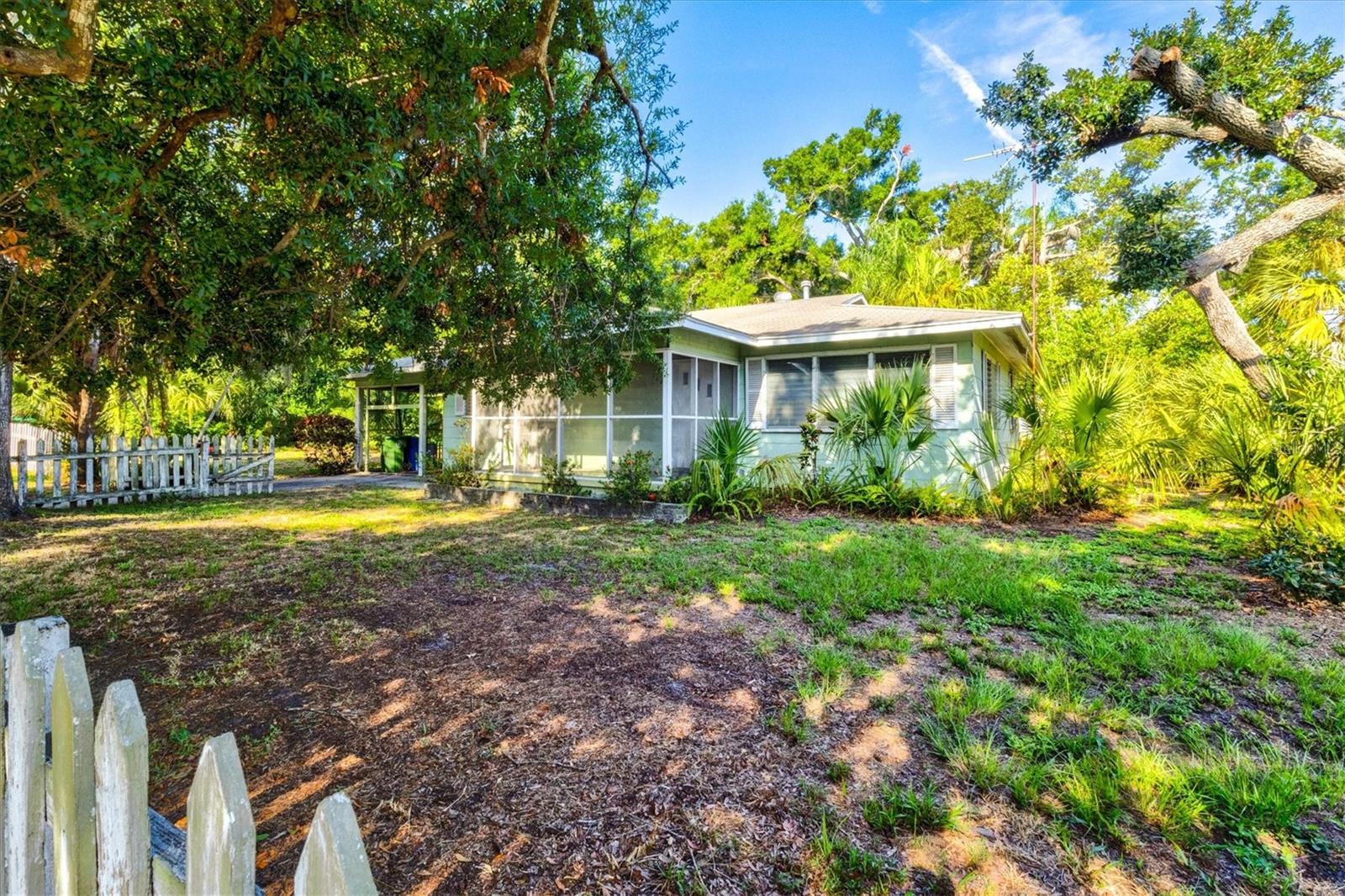 A rare opportunity to own one of West Bradenton's most enchanting homesites. Two adjacent parcels totaling 0.567 acres (approximately 190' x 130') create a remarkable canvas beneath a canopy of majestic oak trees and lush Old Florida landscaping. A charming City of Bradenton park sits just across the street, providing a peaceful backdrop where birdsong and nature are part of everyday life.

The historic bungalow has seen better days, but its hardwood floors, timeless character, and classic Florida architecture hint at the stories it could tell. Whether you choose to lovingly restore this aging home, create a private estate surrounded by mature trees, or explore the potential to subdivide and build multiple residences (buyer to verify with the City), the possibilities are truly exceptional.

The expansive property offers ample room for gardens, guest houses, workshops, or additional outdoor living spaces. Located in Flood Zone X, the seller reports no history of flooding, and underground utilities provide added convenience and peace of mind.

Ideally situated in the heart of West Bradenton, you'll enjoy easy access to shopping, dining, medical facilities, public transportation, and everything the area has to offer—all while feeling tucked away in your own private Old Florida sanctuary.