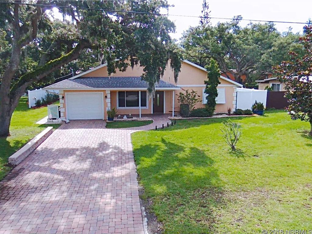 This immaculate 3 bedroom 2 bath home is located in the highly desirable Central Beachside area and its warm and welcoming entry is paved with a beautiful paver driveway and entry. French doors set the tone for the beautiful details this home has in store. Completely remodeled in 2007, features in this split bedroom plan home include fresh paint, new bathroom tile and fixtures, and wall to wall carpeting just installed less than a year ago. Cooking in this homes beautiful kitchen will be easy with lots of counter space to work on, and plenty of cabinets and drawers, modern tile backsplash and wood style tile flooring, and the double oven will insure dinner will be on time. The breakfast bar seats 4 and overlooks a bright and cheery great room. The master bedroom is large with walk in closets that are complete with California cabinetry. Relax bug free after a long day in the hot tub of the screen room while enjoying views of the well manicured back yard which features a dog run and is completely fenced in for privacy by attractive white vinyl fencing. This home truly has a lot to offer from inside out and all within close proximity to all of NSBâs dining, entertainment, and shopping. ;Water: City