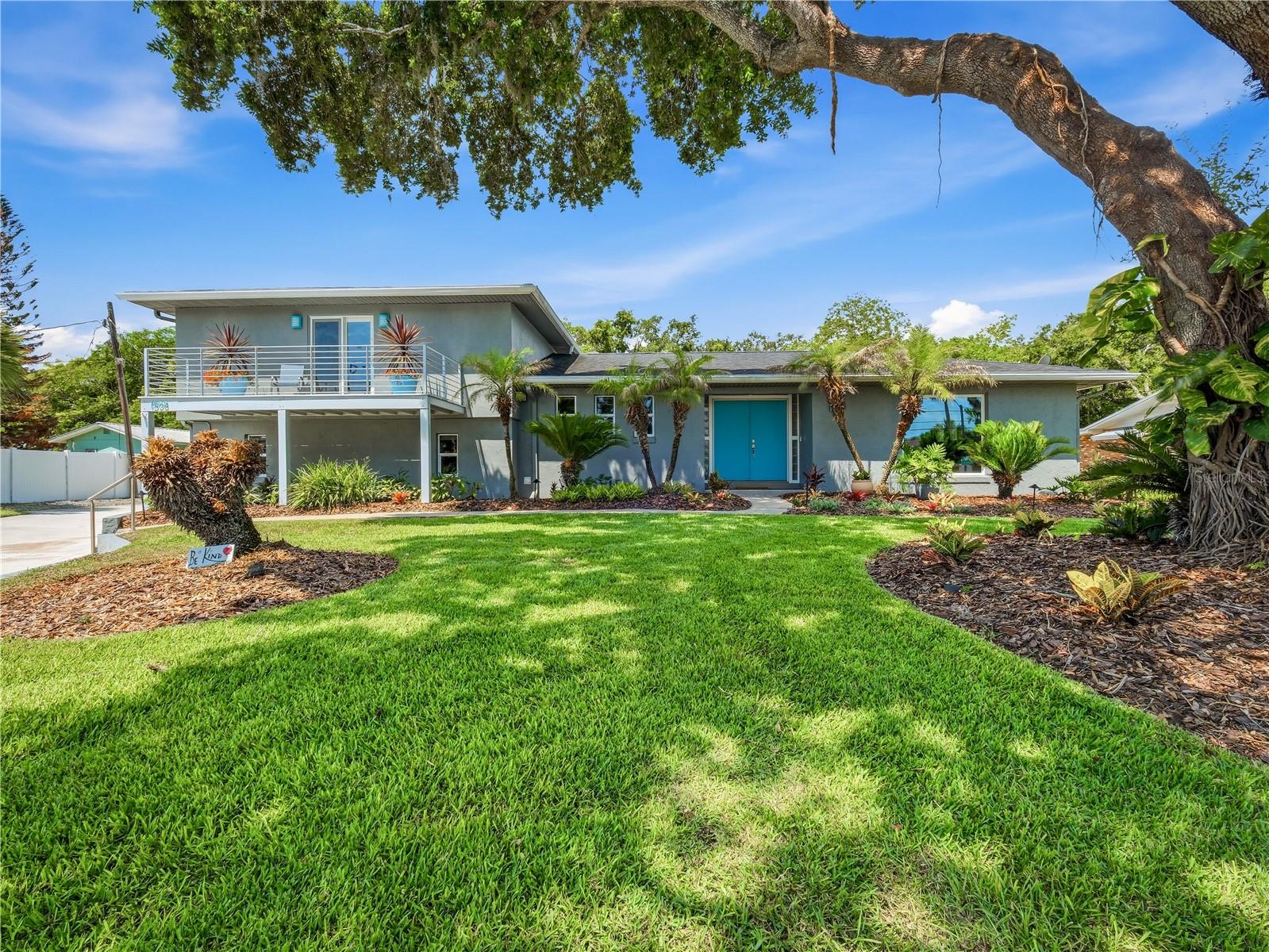 Beautifully renovated 3 bedroom, 2.5 bath pool home situated on a picturesque half-acre nicely elevated parcel along sought-after Riverside Drive in New Smyrna Beach. Surrounded by mature trees and lush landscaping, this light-filled home offers an open floor plan with abundant windows and inviting living spaces throughout. The living room features a gas fireplace and a large picture window overlooking the expansive front lawn, framed by a magnificent live oak. A spacious family room/sunroom with wet bar opens to the covered lanai and screened, gas-heated saltwater pool and spa, creating the perfect setting for indoor-outdoor living and entertaining. The kitchen is designed for both functionality and style, offering abundant cabinet and counter space, stainless steel appliances, a 2024 gas cooktop, pot filler, and instant hot water dispenser. The dining room includes a built-in buffet, generous storage, and ample space for gatherings. A private main-level office can easily serve as a fourth bedroom. Additional features include a large laundry room with storage.  Tiled flooring throughout. The spacious primary suite features a private balcony perfect for enjoying sunrise views, a custom walk-in closet, and a newly renovated walk-in shower. The guest bath offers double vanities for added convenience. Car enthusiasts, hobbyists, and golf cart owners will appreciate the oversized 35' x 23' garage, providing room for two vehicles plus a golf cart, workshop, or additional storage. An expansive driveway offers plenty of extra parking. Quality construction and updates include Andersen “Stormwatch” double-pane windows and sliders, a 2020 roof, and natural gas service for the cooktop, tankless water heaters (2019), fireplace, pool, spa, and outdoor grill connection. HVACs 2022.  The private, fenced backyard retreat has fruit trees including lemon, tangerine, peach, lime, papaya, and olive; landscape lighting; an outdoor shower; and a screened garden shed with electric and water. The irrigation system tied to a well helps keep the grounds lush year-round at minimal cost. With ample space on this half-acre property, there is potential for a guest house or in-law quarters. Conveniently located near Smyrna Yacht Club and the shops, dining, and events on Canal Street, this exceptional property offers the best of New Smyrna Beach living.