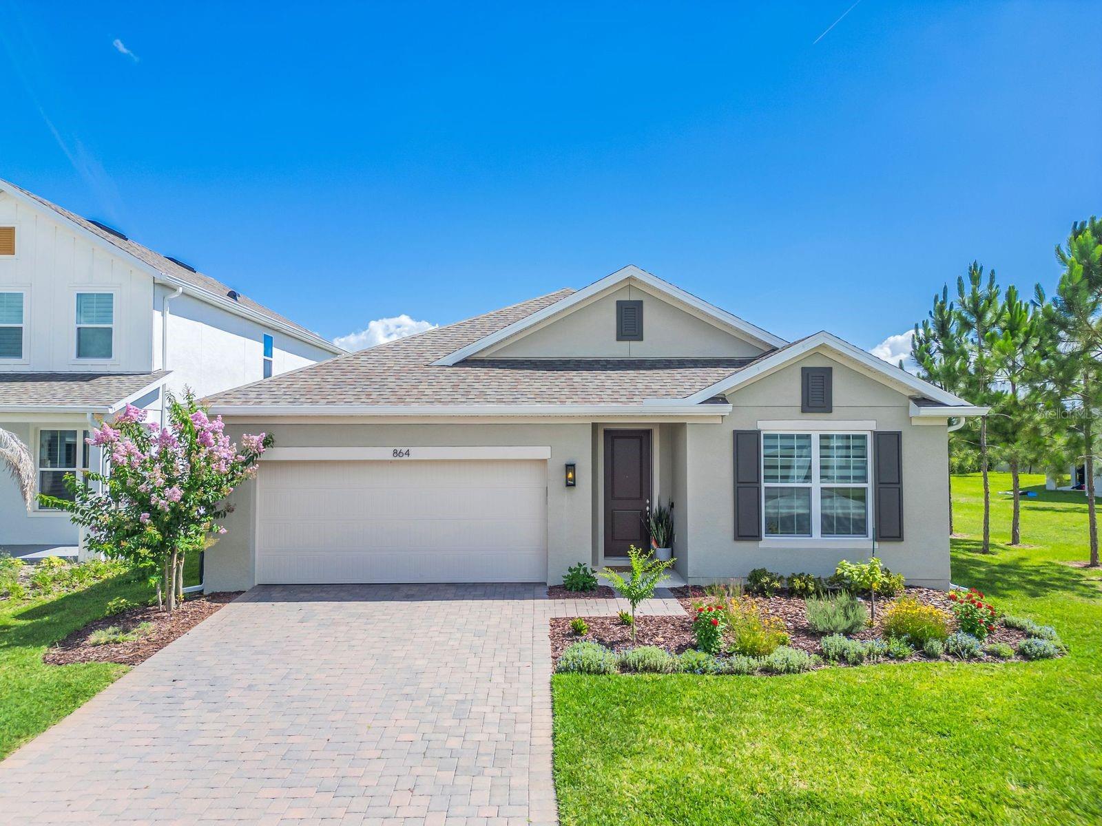 This stunning open-concept home features 4 Bedrooms and 2 Baths, with a separate Living Room / Flex space, and luxurious finishes throughout. The spacious Great Room flows seamlessly to the covered Lanai, ideal for entertaining or relaxing outdoors. Enjoy impressive 9'4" ceilings throughout and stylish tile flooring in the main living areas. The Deluxe Kitchen features 42" upper cabinets with crown molding, sleek quartz countertops, large center island, and stainless-steel appliances including built-in wall oven and cooktop. The private Primary Suite includes a luxurious ensuite Bath featuring a large walk-in closet, dual-sink vanity with quartz tops, and a walk-in shower with wall tile surround and glass enclosure. Curb appeal shines with attractive landscaping, and a brick paver driveway and lead walk. Don't miss your chance to call this exceptional home yours! Enjoy the resort-style community pool and cabana, recreation area, and playground. The Florida Turnpike is just under a mile from community and provides easy access to all of Central Florida, including downtown Orlando, the Orlando International Airport, and all the major destinations. Enjoy the extensive outdoor recreation Minneola has to offer from biking through the city’s rolling hills, fishing, boating, or kayaking in Clermont’s Chain of Lakes or across the street at the Minneola Athletic Complex that offers fun for the whole family.