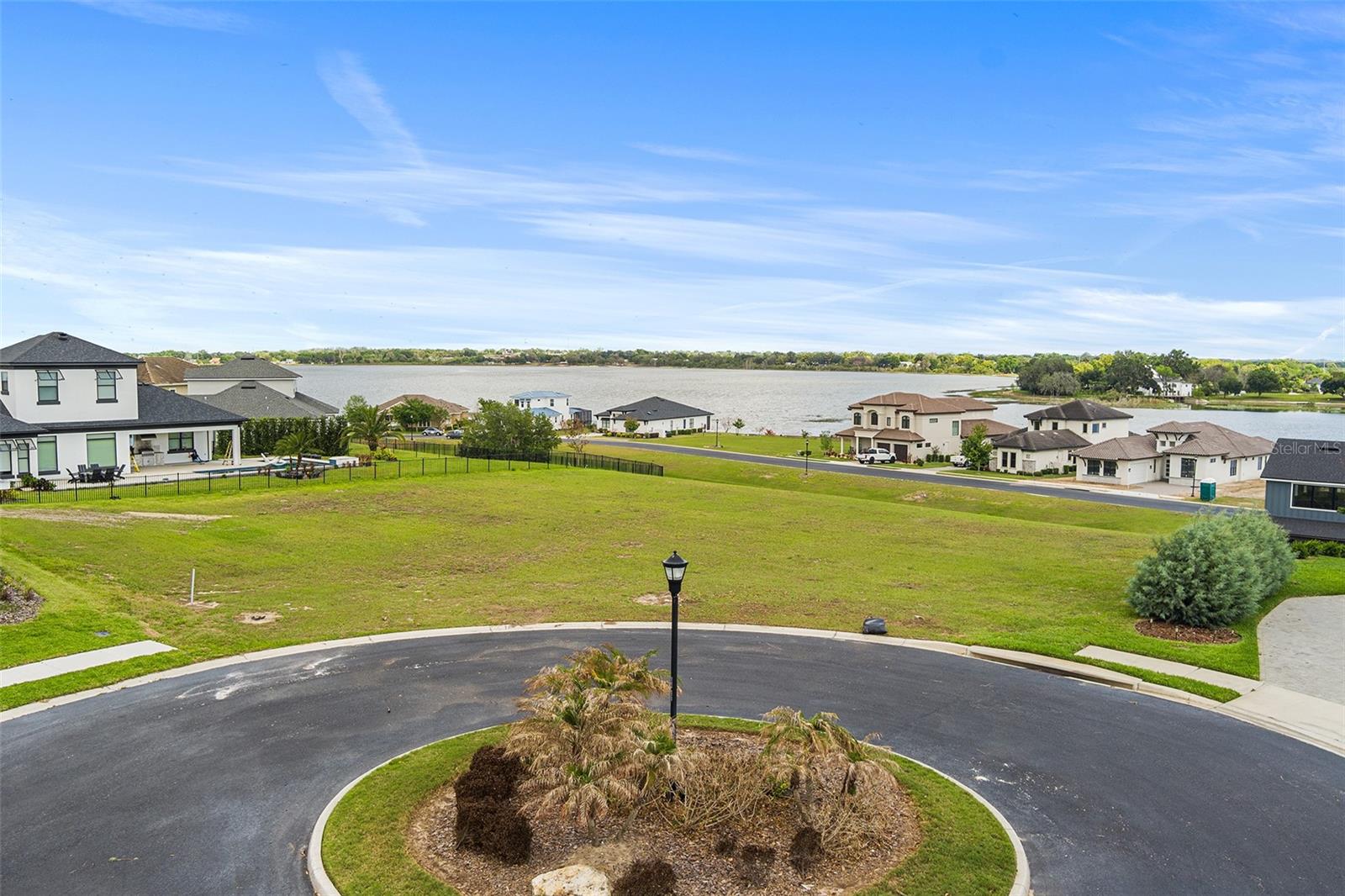 Oversized 0.31-acre buildable lot located in the gated custom home community of Water Ridge. Positioned on a cul-de-sac, this homesite offers lake views of Lake Alfred and features a larger lot width than many surrounding properties, providing flexibility for a variety of custom home designs and floorplans. The elevated setting allows for enhanced views of the surrounding lakes and natural scenery. Water Ridge is an established, upscale community known for its custom homes, well-maintained environment, and resort-style amenities.
Community amenities include multiple pools, clubhouses, fitness center, tennis courts, pickleball courts, basketball courts, fishing docks, boat ramps, lake access, and boat/RV storage. No CDD fees. Conveniently located with easy access to I-4, providing connectivity to Orlando, Tampa, shopping, dining, and Central Florida attractions.