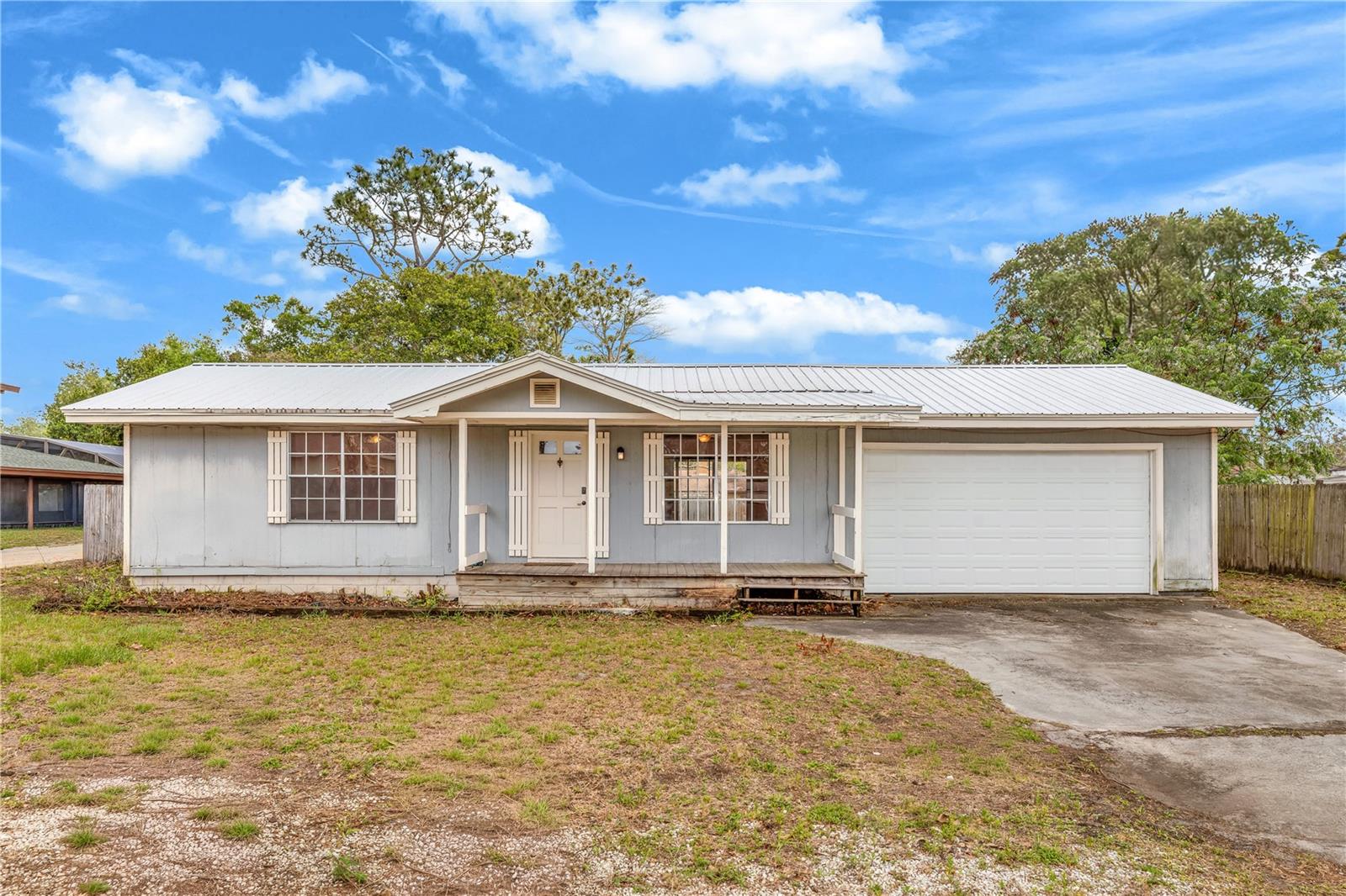 Two bedroom, two bathroom, two-car garage home located in the desirable Port St. John community. Nestled in a quiet neighborhood, this property offers a wonderful opportunity for a FIRST-TIME HOMEBUYER, INVESTOR, or anyone looking to add their own personal touches and build equity over time. The home features a durable METAL ROOF and a NEW 2024 AC SYSTEM, and Brand new water heater, providing peace of mind on two of the most important big-ticket items. A charming FRONT ROCKING CHAIR PORCH welcomes you in. The layout offers a functional GALLEY-STYLE KITCHEN WITH ADJACENT DINING AREA, all flowing into a spacious GREAT ROOM with UPDATED LAMINATE FLOORING. The PRIMARY BEDROOM FEATURES LAMINATE FLOORING, adding warmth and character. THE SECOND BATHROOM HAS BEEN FULLY REMODELED AND UPDATED. Out back, enjoy a LARGE ENCLOSED UNDER-TRUSS PATIO WITH DECK, perfect for relaxing or entertaining. Port St. John is part of Florida’s sought-after Space Coast, conveniently located near NASA and the Kennedy Space Center, with nearby facilities for SpaceX and Blue Origin. With easy access to the coast, local amenities, and major employers, this location continues to grow in popularity. A SOLID HOME WITH GREAT BONES, AND PLENTY OF POTENTIAL TO MAKE IT YOUR OWN.