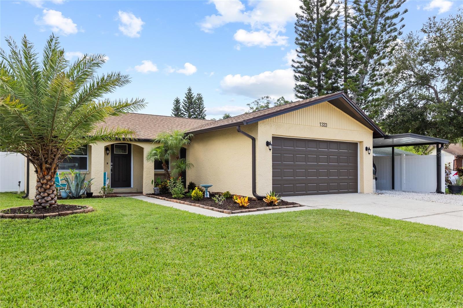 This spacious home offers a fantastic combination of indoor and outdoor living with **4 comfortable bedrooms**. With numerous improvements completed over the years, this property provides plenty of space, functionality, and value.

Recent major updates include a **complete new roof and gutter system installed in December 2025**, a **new Rheem HVAC system installed in 2019**, impact-resistant energy-efficient windows (2016), and **all-new kitchen appliances installed in 2024** (with the refrigerator replaced in 2019). Additional energy-saving features include **blown insulation throughout the home and garage completed in 2020**.

The outdoor space offers plenty of room to enjoy Florida living. A **fully enclosed and waterproofed lanai completed in 2023** expands the usable living area, while the **approximately 800 square feet of paver patio space** creates an ideal setting for outdoor gatherings, grilling, and relaxing. The backyard is enclosed with a **PVC vinyl privacy fence installed in 2021**, featuring three gates, including a 10-foot gate with street access that allows easy entry for vehicles, trailers, or equipment. A **new 14' x 8' weatherproof shed**, added in August 2025, provides excellent storage space.

The property also features updated landscaping with St. Augustine sod, an irrigation system, and four attractive palm trees, including Sylvester and Foxtail varieties. A **temperature-controlled two-car garage**, additional carport, and **new garage door and opener installed in 2020** add convenience and flexibility.

Inside, you'll find **new room-darkening window treatments (2024)**, updated ceiling fans with lighting (2021), and remodeled bathrooms with modern glass shower doors. Whether you're looking for extra workspace, room to entertain outdoors, or practical storage and parking options, this home offers a variety of features that make it a great opportunity.