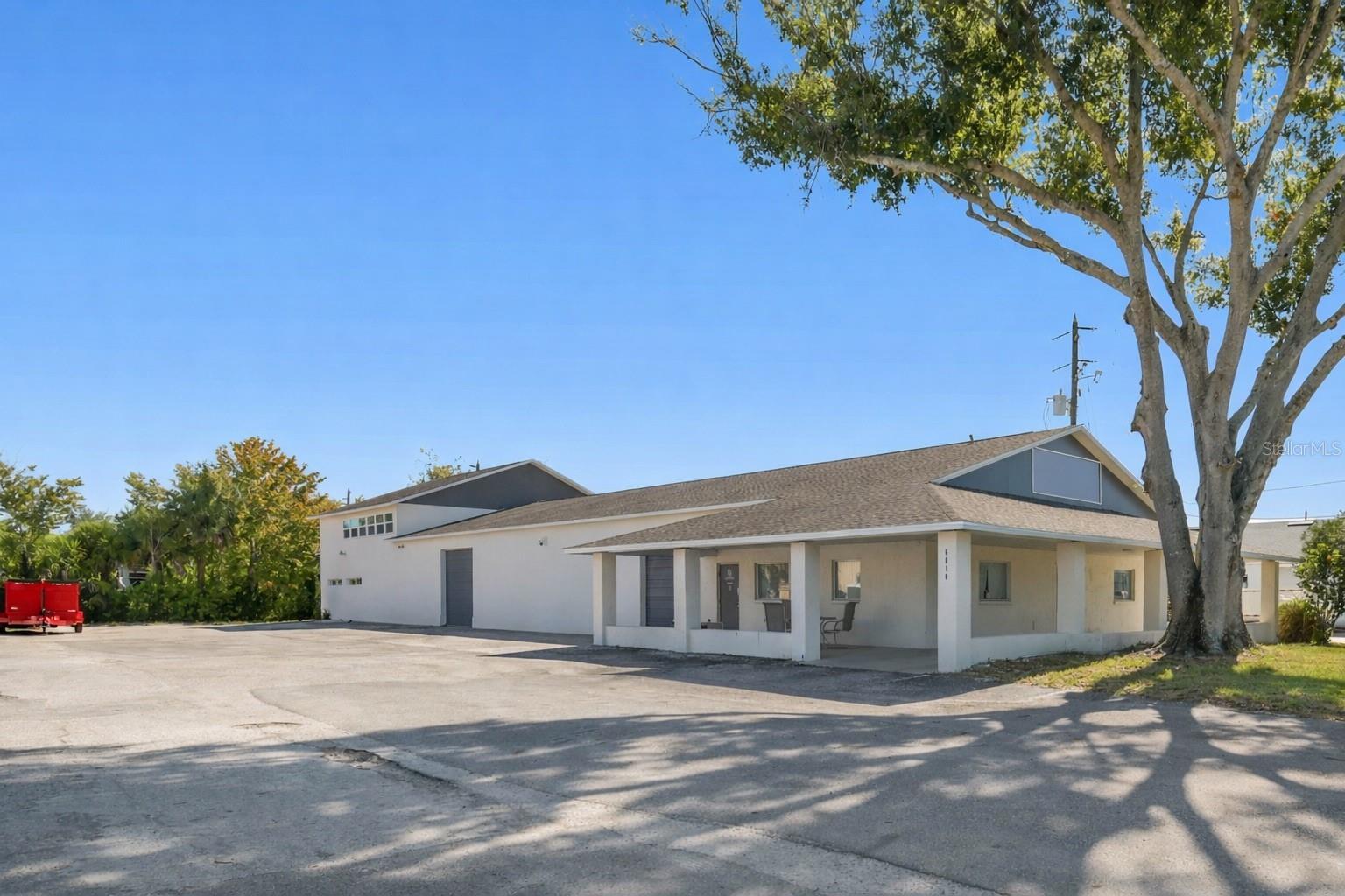 A rare mixed-use opportunity in the City of Port Richey, North Tampa Bay. Zoned C3, this versatile commercial building delivers the ideal combination of office, warehouse, and residential space—perfect for an owner-user, investor, or business needing flexibility and climate-controlled functionality. The first floor offers multiple entry points, dedicated 5 office areas, a full bath and a half, a kitchenette, and large open sections that adapt beautifully for light manufacturing, storage, assembly, training, or additional office build-out. The warehouse area features 2 10ft tall overhead doors, excellent ceiling height, abundant natural light, and air-conditioned space for clean, temperature-controlled operations. The second floor adds tremendous value with a fully finished apartment featuring two bedrooms, a full bath, a spacious living area, and a remodeled kitchen with granite countertops and stainless steel appliances. It works perfectly for an on-site manager, executive suite, meeting space, or administrative offices.
This property is also ideal for lifestyle-driven buyers. The massive warehouse space can become the ultimate recreational showroom for boats, jet skis, cars, or hobby collections, the dream space to store all your toys. With the Cotee River and nearby boat ramps just around the corner, you have quick access to water activities, marinas, and waterfront restaurants. Ridge Road connects directly to the Veterans Expressway/Suncoast Parkway, offering easy north–south commuting to Tampa, the airport, and surrounding areas. Additional highlights include abundant parking for at least 20 vehicles, easy drive-around access, three-phase power, and a central location near US-19, Ridge Road, SR-52, and SR-54. A perfect fit for businesses needing clean, climate-controlled space, storage and distribution capability, office and warehouse flexibility, or a unique mixed-use setup with on-site living or workspace potential.