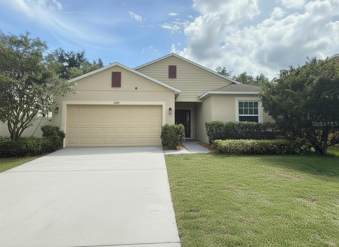 One or more photo(s) has been virtually staged. Lowest Price per foot in Windsong at Leesburg! Seller will put on a NEW Roof prior to closing with accepted contract! Welcome to 5909 Windsong Oak Drive NEAR the quiet culdesac in the very back of this quiet community, in the desirable Windsong at Leesburg community—where modern comfort, convenience, and Florida living come together beautifully. 

This move-in-ready home offers 1,875 square feet of thoughtfully designed living space featuring attractive stone accents, durable block-and-stucco construction, energy-efficient double-pane windows, and a spacious two-car garage.

Step through the impressive foyer and discover an open-concept floor plan highlighted by large ceramic tile flooring, abundant natural light, and spacious gathering areas perfect for entertaining or everyday living. The heart of the home is the oversized kitchen featuring rich espresso cabinetry, granite countertops, stainless steel appliances, abundant prep space, and a large dining area ideal for family dinners and holiday celebrations.

The expansive living room flows seamlessly to the large covered lanai through oversized sliding glass doors, creating the perfect indoor-outdoor lifestyle. Whether you're enjoying your morning coffee, relaxing after work, or hosting friends and family, this inviting space is designed to be enjoyed year-round.

The oversized primary suite serves as a private retreat with plenty of room for a sitting area, a huge walk-in closet, and a luxurious ensuite bath featuring dual vanities, solid-surface countertops, a soaking tub, and a separate walk-in shower. Secondary bedrooms are with comfort and privacy, while the oversized laundry room provides additional storage and functionality.

Beyond the home itself, Windsong at Leesburg offers exceptional community amenities with low HOA fees. Residents enjoy a beautiful community pool, covered seating and gathering areas, and a playground, creating the perfect setting for relaxation, recreation, and neighborhood gatherings.

Location is another standout feature. Conveniently situated near Publix, shopping, restaurants, medical facilities, and daily conveniences, everything you need is just minutes away. Outdoor enthusiasts will appreciate the close proximity to public boat ramps and the area's beautiful lakes, providing endless opportunities for boating, fishing, kayaking, and waterfront fun.

Commuters will love the easy drive to Clermont, Minneola, and surrounding Central Florida destinations, while wine enthusiasts can enjoy nearby weekends at Lakeridge Winery, one of Florida's premier wineries known for its scenic vineyards, festivals, and live entertainment.

If you've been searching for a move-in-ready home in Leesburg with granite countertops, stainless steel appliances, an oversized primary suite, covered lanai, low HOA fees, community pool, playground, and convenient access to shopping, boating, and Clermont, then 5909 Windsong Oak Drive is the opportunity you've been waiting for.

Schedule your private showing today and discover why this exceptional home stands out from the competition.