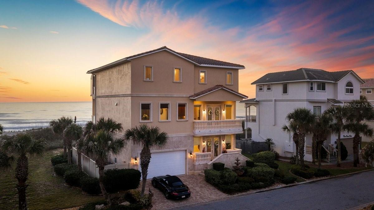 Direct oceanfront living awaits in this exquisite custom home located on the coveted Ocean Dune Circle in Armand Beach Estates. This private, gated beachside community offers a quiet and serene setting with exceptionally low HOA fees and direct access to miles of pristine coquina sand beach, perfect for peaceful walks in either direction.

Built in 2007, this custom home showcases exceptional craftsmanship and premium materials throughout, including custom-milled moldings, fine woodwork, porcelain, marble, and granite flooring, bronze custom stair railings, and beautiful cherry built-ins. Every detail reflects the highest level of quality and attention to luxury.

Spanning three levels with abundant natural light and expansive views of the Atlantic Ocean, the home features a private elevator for easy access between floors. The first level includes two generously sized bedrooms that sit up high, offering beautiful ocean views. The second level boasts an open-concept living area with a gas fireplace and dramatic tall ceilings that flow seamlessly into a gourmet kitchen equipped with two adjacent prep kitchens and a premium appliance package. A spacious lanai provides the ideal spot to relax and enjoy sweeping water views and brilliant sunrise vistas. The third level features a loft/office with a wet bar, and custom built-in shelving with lighting. Along with two luxurious suites highlighted by a striking shared solarium enclosed balcony that offers breathtaking sky and ocean views.

Resort-style living continues outdoors with a private pool and spa, plus a convenient private dune walkover that leads directly to the quiet coquina sand beach just steps away. Residents also enjoy easy access to the community pool, and a short bike or golf cart ride takes you to Malacompra Park. Additional highlights include 75 feet of direct oceanfront frontage, high and dry stem wall concrete block construction, a whole-house Generac generator, and so much more.

This rare combination of privacy, luxury finishes, and effortless beachfront access makes this home the perfect coastal retreat for discerning families. 
Lot 7 is not included in the sale. Seller will separate at the time of closing.