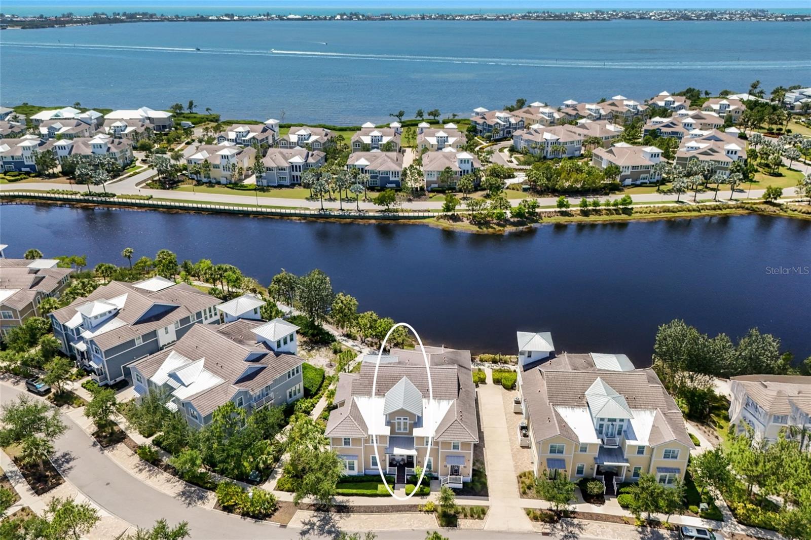Tucked into the exclusive Mangrove Walk enclave of Harbour Isle, this 3BD/2BA condo offers a gracious take on coastal living—just before the bridge to Anna Maria Island, in a gated waterfront community that feels worlds away.
Inside, sunlight pours through expansive windows framing serene views of Sapphire Lake. Soaring ceilings, beamed detailing, and soft shiplap accents lend a sense of easy sophistication, while the open layout invites the kind of unhurried days the coast is known for. The kitchen is the natural heart of the home, anchored by an oversized island and finished with stainless appliances and generous cabinetry—designed for slow mornings and long evenings alike, flowing effortlessly into the dining and living spaces.
The primary suite is a quiet retreat, with water views, dual vanities, and ample closet space. A flexible den offers room to work, read, or welcome guests. Step out to the screened back porch for your private slice of the tropics—an ideal spot to linger over coffee or sunset cocktails. A private elevator and attached two-car garage round out the thoughtful details.
Life at Harbour Isle unfolds around the stunning Beach Club on Anna Maria Sound, where a sky bar and social lounge, resort-style pool and spa, fitness center, fire pit, private beach, and kayak launches set the tone. Walking and biking trails wind through the community, with additional neighborhood pools, grills, and on-site dining never far. Just beyond the gates, the Compass Hotel marina and Margaritaville-inspired Floridays restaurant complete the picture.
A rare opportunity to live the island life—gracefully, and just minutes from Anna Maria.