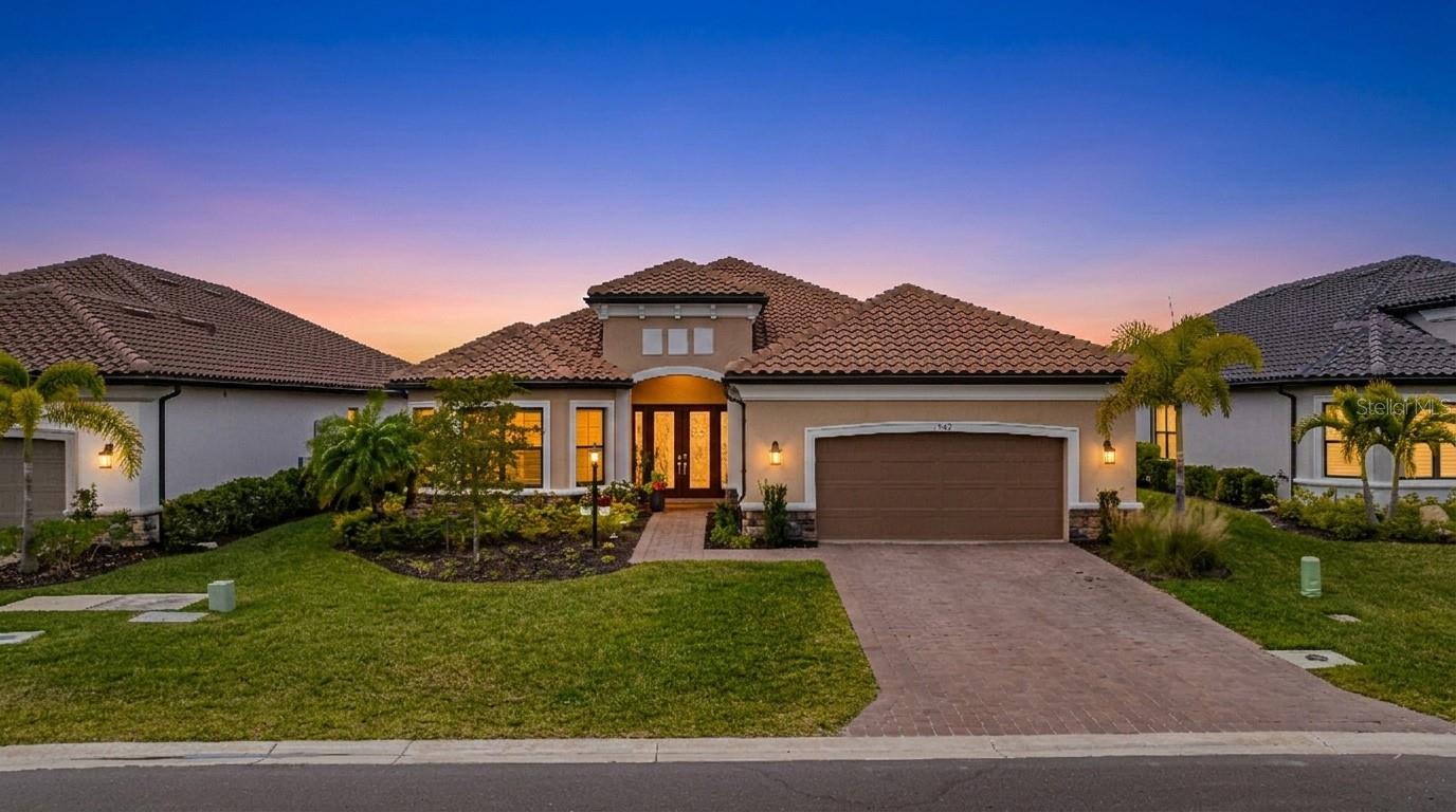Experience waterfront living in this Taylor Morrison Pallazio model with Mediterranean elevation, located in Esplanade Lake Club. Positioned on a premium lakefront homesite, this upgraded residence offers approximately 3,126 square feet with 3 bedrooms, a private study, and 3 full bathrooms, designed for seamless indoor-outdoor living. A grand foyer opens to an expansive open-concept layout featuring tray ceilings, crown molding, designer lighting, and wide plank laminate flooring throughout the main living areas. The great room flows effortlessly into the gourmet kitchen and dining area, creating an ideal setting for both everyday living and entertaining. The kitchen is appointed with GE Café appliances, quartz countertops, custom cabinetry, a large center island with sink, designer hood, and upgraded pendant lighting, all overlooking the main living space. The primary suite offers a private retreat with a bay window sitting area and a spa-style bathroom featuring dual vanities and a walk-through shower. Outdoor living is a defining feature, with an extended covered lanai showcasing a fully equipped outdoor kitchen with built-in grill, a spacious screened enclosure, and multiple seating and dining areas overlooking expansive lake views, providing a true Florida lifestyle setting for entertaining and sunset enjoyment. Additional highlights include impact-resistant hurricane glass, a tankless gas water heater, and a tandem three-car garage with epoxy flooring and pull-down attic stairs for additional storage access. Located within Esplanade Lake Club, an award-winning lakeside community on Lake Como, residents enjoy a true resort-style lifestyle with amenities including Bahama Bar and Restaurant, Dedicated Lifestyle Director, stunning resort pool, clubhouse with full-service spa, fitness center and hobby room, community boat slip, bike and jog paths, tennis courts, pickleball courts, bocce courts, two water skiing slalom courses, two dog parks, and a fishing pier. A boater’s dream, the community also features a marina, boat ramp, kayak launch, floating pier, and direct lake access. Ideally located just east of I-75, this home offers convenient access to Southwest Florida International Airport, beaches, golf courses, upscale shopping, dining, and major employment corridors, delivering a refined blend of luxury, lifestyle, and location in one of Fort Myers’ most sought-after communities.