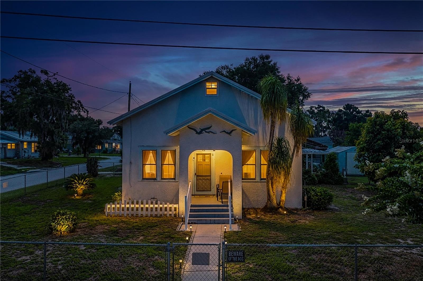 Discover the character and possibilities this unique older Florida home has to offer! Situated on a spacious corner lot with a fenced yard, this wood-frame home with a stucco exterior features two bedrooms and two bathrooms in the main living area. An additional upstairs space provides plenty of room for storage or the potential to be finished with drywall and transformed into a third bedroom, home office, hobby room, or additional living space.One of the standout features of this property is the separate garage area, complete with its own bathroom and shower, offering additional convenience and versatility. Whether you are looking for workshop space, additional storage, or room to accommodate your individual needs, this property offers plenty of possibilities.The spacious fenced yard provides room to enjoy the outdoors, while the large corner lot adds to the appeal of this unique property. Conveniently located near shopping, dining, major highways, and Central Florida’s world-famous theme parks. Centrally located in the heart of Florida, this property offers a great combination of character, space, convenience, and potential. Bring your ideas and make this one your own!