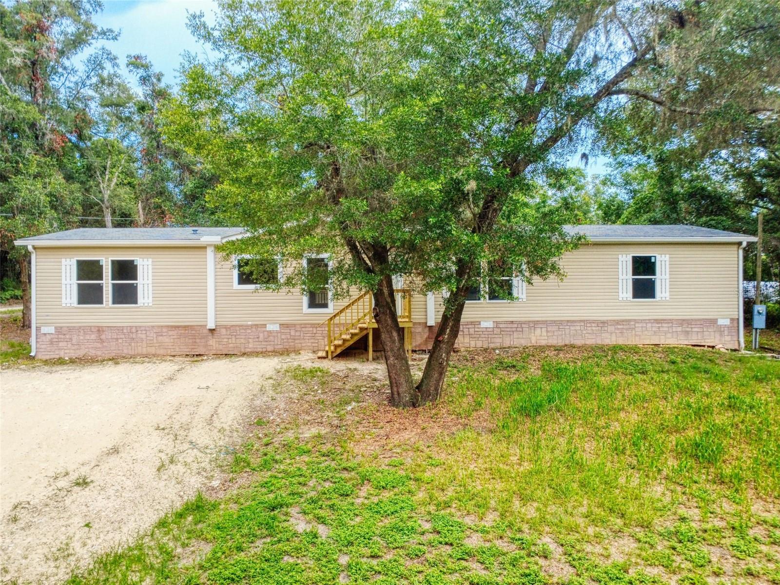 Seller Credits Available! Look no further. This beautifully updated 4-bedroom, 2-bath manufactured home, built in 2016, offers over 2,000 square feet of comfortable living space and sits on a spacious Lucious 0.51-acre Corner Lot in the Lake Weir Heights area.

Step inside to find a fresh, modern interior featuring new stainless steel kitchen appliances, sparkling quartz countertops, new shaker-style cabinetry, and luxury vinyl plank flooring throughout. The open and inviting floor plans offers a room for formal dining or a family room. 
The primary suite offers a comfortable retreat with new LVP flooring and a spacious en suite complete with dual sinks, separate tub and shower, private toilet room, and a large walk-in closet. Three additional bedrooms are situated on the opposite side of the home for added privacy. 

One of the standout features of this property is the impressive 24' x 16' backyard deck, perfect for relaxing, hosting family gatherings, or enjoying Florida's beautiful weather year-round. The backyard also features a chain-link fence, offering space for pets and outdoor enjoyment.

Roof and HVAC (2016) and well and septic (2017)

With no HOA, a lot that is slightly larger than a half-acre, and a convenient location near Lake Weir bring your boat, Belleview, The Villages and local shopping and dining, this property offers the perfect blend of comfort, convenience, and country living. 

Nothing to do here but move right in and enjoy country living at its finest!