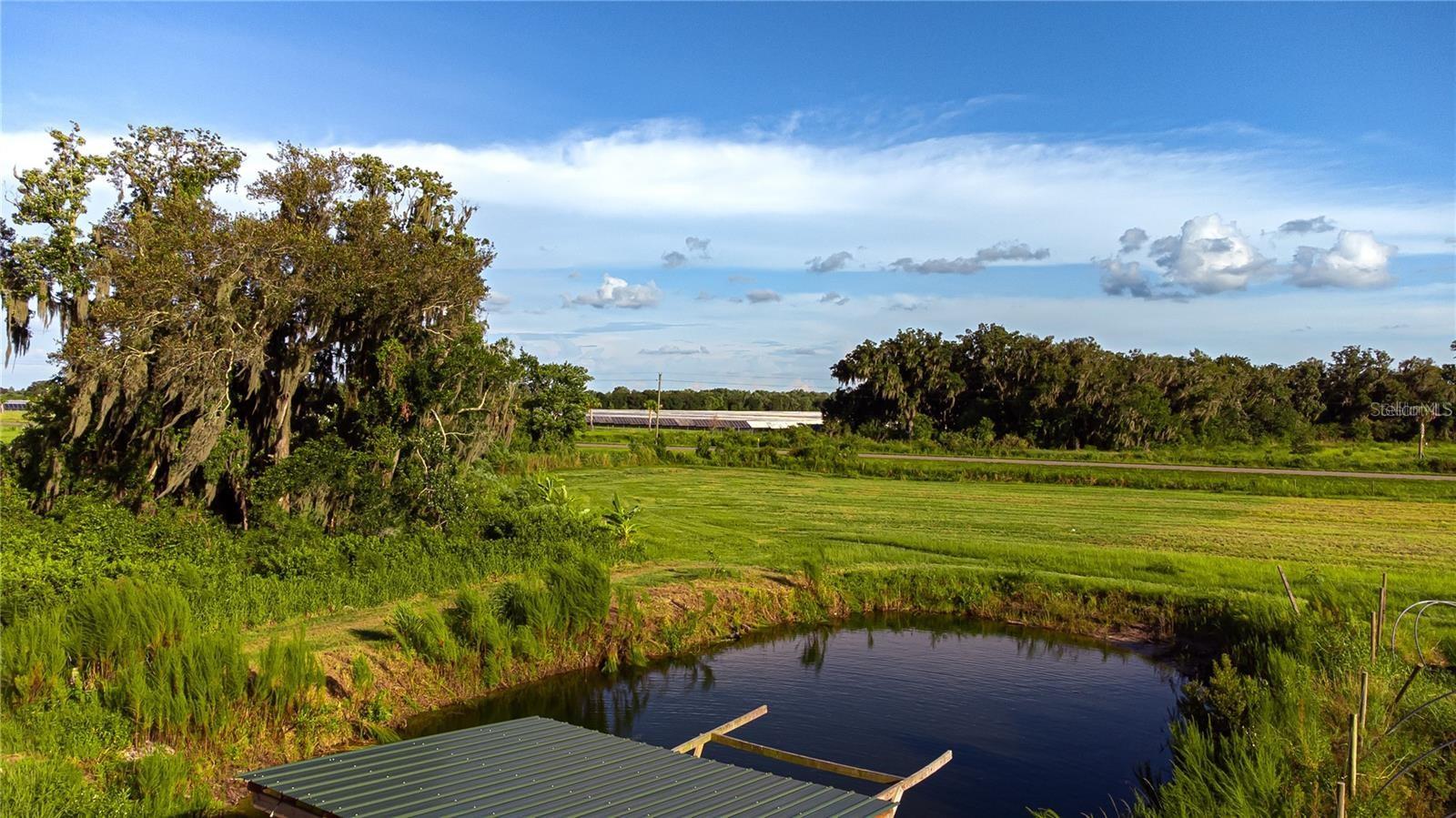 Bring your vision to life on this 5.5-acre slice of Florida freedom—no deed restrictions, no HOA, and no CDD. Even better, mineral rights convey with the property, giving you true ownership from the ground up. Whether you’re planning a custom home, a small farm setup, or simply want wide-open space for animals, gardens, and outdoor living, this land is ready for it.

The heavy lifting is already started with a well already drilled, plus a barn/outbuilding ideal for a tractor, equipment, or storage. Enjoy the peaceful setting with a pond—perfect for relaxing and casting a line.

You’ll love the balance of privacy and convenience: tucked away from the busy pace, yet just minutes to Parrish shopping, dining, and new growth. Nearby homes are already being built to the east, making this a great opportunity to secure acreage while it’s still available.
