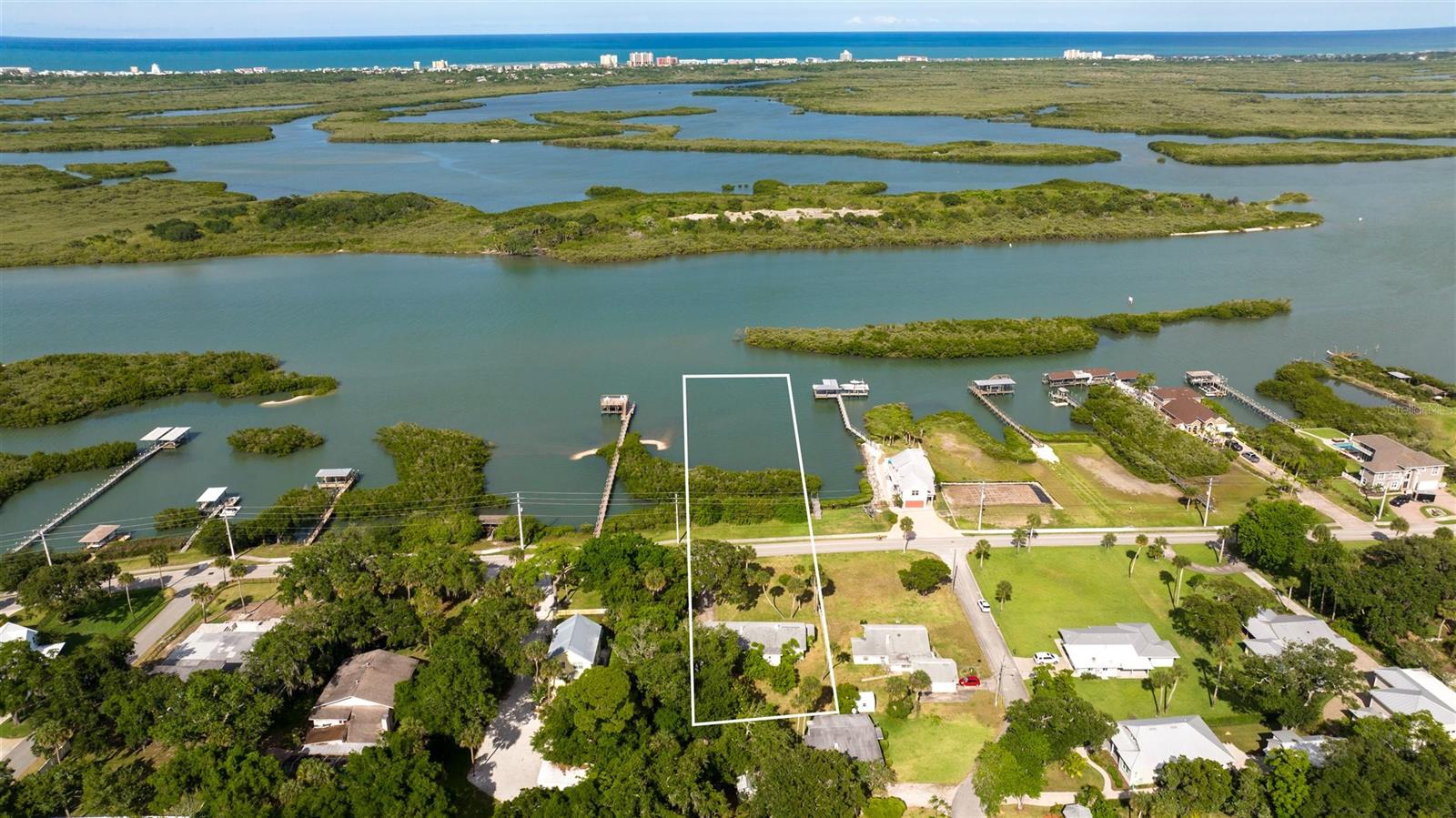 ACCEPTING BACK UP OFFERS!  Huge Lot on Riverside Dr with Riparian Rights!!! Home sits nice and high to maximize the views of the Intracoastal from kitchen, Living room and office. Lots of room to add on or build your new dream home.  This is a rare chance to own such a large homesite with riparian rights. Home was built in 1950. 2 Bedr, wrap around 1 and 1/2 bathroom, eat-in kitchen. Den or office,  fireplace in living room with big picture window to view Intracoastal. Drive through large 1 car garage and enclosed porch. Perfectly ready to be cleaned up and lived in while you make plans for your home and dock. Located just south of the New Smyrna Line. Minutes to the beach or the best fishing around in Mosquito Lagoon. ;Water: City