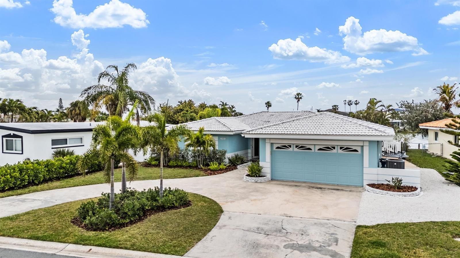 Virtually Staged. Experience the ultimate Florida waterfront lifestyle in this completely updated 3-bedroom, 2-bathroom, 2-car garage home in Treasure Island. Perfectly positioned on a canal with direct boating access, this property offers the ideal blend of luxury, comfort, and coastal living just half a mile from the beach. Whether you’re searching for a primary residence, second home, or a beachside retreat, this home delivers the lifestyle buyers are looking for in Treasure Island real estate.

Step inside to an open floor plan filled with natural light and designed for both everyday living and effortless entertaining. The heart of the home is the chef’s kitchen, featuring GE Café Series white appliances, striking blue soft-close cabinetry with pull-out drawers, granite countertops, and bar stool seating. The kitchen flows seamlessly into a spacious dining area and overlooks the family room, creating a connected space perfect for hosting gatherings or relaxing after a day on the water.

Luxury vinyl flooring in a light brown tone runs throughout the home, enhancing the bright, beach-inspired aesthetic. The primary suite and two additional bedrooms have all been thoughtfully updated, along with beautifully renovated bathrooms showcasing custom tile work in the showers.

Off the family room, a Florida room provides additional flexible living space and opens through sliding glass doors to your private outdoor oasis. The pavered pool area features an open saltwater pool, ideal for cooling off on warm Florida days or enjoying evenings under the glow of exterior trim lighting that surrounds the home, creating the perfect ambiance for entertaining.

For boating enthusiasts, the newer dock with a 10,000-pound lift offers quick and easy access to the water, making this canal-front home a true boater’s paradise. Located in a golf cart-friendly community, you can cruise to the beach, local restaurants, and shopping just minutes away.

Live where others vacation and enjoy everything Treasure Island has to offer, from sandy beaches and waterfront dining to a relaxed coastal lifestyle that feels like a getaway every day. IT'S NOT JUST A HOME...BUT A LIFESTYLE! SELLER HAS PERMITS IN PLACE IF NEW BUYER WOULD LIKE THE PROPERTY RAISED, ASK FOR DETAILS