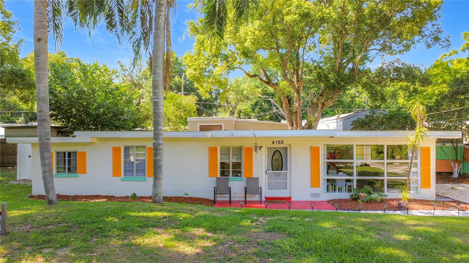 Charming and beautifully updated bungalow just minutes from quaint Downtown Mount Dora and Downtown Tavares! This unique 1 bedroom home offers a surprisingly spacious layout featuring a large living room filled with natural light, dining area with oversized picture windows, kitchen with breakfast bar seating, inside laundry room with storage, and an additional large storage closet for extra convenience.

Step outside and fall in love with the tropical vibe and colorful personality of this property! The freshly landscaped yard, vibrant accents, mature palm trees, decorative walkways, and fully fenced backyard create the perfect private retreat for relaxing or entertaining. The home also features modern finishes, bright open spaces, mini split AC system, and plenty of parking with NO HOA restrictions.

Located only minutes from Downtown Mount Dora, known for its charming boutiques, restaurants, pubs, shopping, festivals, and waterfront atmosphere, plus just a short drive to vibrant Downtown Tavares, America’s Seaplane City, offering waterfront dining, craft breweries, entertainment, local events, and lakeside fun year round. 

Whether you are looking for a primary residence, vacation getaway, investment property, or potential Airbnb opportunity, this home offers endless possibilities in an incredible location!