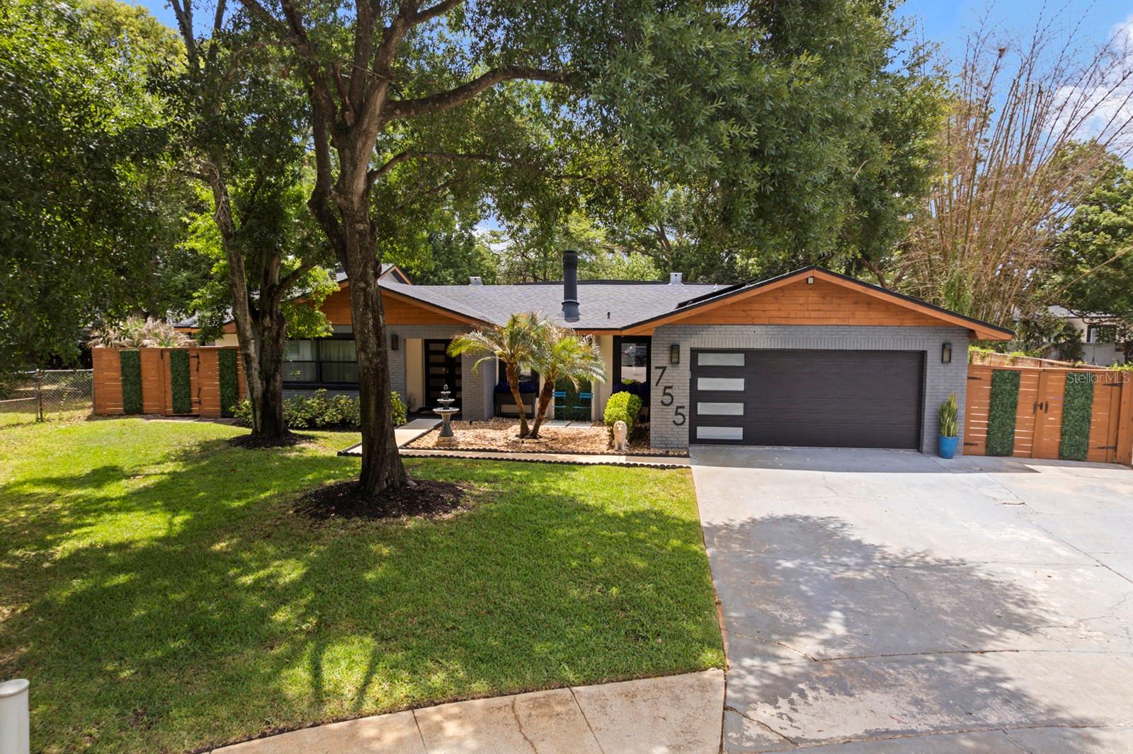 This is the one you've been waiting for- a SLEEK MODERN HOME, where EVERY MAJOR SYSTEM AND FINISH has been REPLACED, REFRESHED and ELEVATED to perfection and minutes from Winter Park without the WP price tag! Located at 755 Woodside Road in the community of Forest Brook in Maitland with 3,054 Sq Ft. of living space, in a quiet CUL-DE- SAC, this 3 BEDROOM 3 FULL BATHROOM POOL home with 2 Car garage on a .31 ACRE LOT is effortless Florida living.**SOLAR PANELS-(Avg. UTITLITIES $40/MONTH) From the moment you arrive you will be impressed with the mature, manicured landscaping and architectural features that sets the tone for the quality you will find inside. The EXPANSIVE OPEN FLOOR PLAN draws you in with an effortless flow between living, dining, and entertaining spaces.  SLEEK MODERN CABINETRY, MARBLE FLOORING and DESIGNER FIXTURES elevate every room. The chef-inspired kitchen features a LARGE CENTER ISLAND perfect for casual dining, meal prep or gathering with guests.  A stylish PASS THROUG BAR connects seamlessly to the Florida Room making entertaining a breeze. The OVERSIZED PRIMARY SUITE is a true retreat with MARBLE FLOORING, an abundance of  natural light and CUSTOM SLIDING GLASS DOORS leading to the expansive pool deck. The en-suite bathroom features FLOATING VANITIES, MARBLE FLOORING and a SEAMLESS GLASS ENCLOSED SHOWER and STAND ALONE TUB that continues the modern aesthetic that feels like a five star hotel everyday. Laundry with sink and overhead cabinets is centrally located near the kitchen and primary suite. The focal point of the family room is the stunning MARBLE FACED FIREPLACE. Two generously sized secondary bedrooms are located off the family room, sharing a beautiful bathroom featuring marble floors, floating dual sink vanity and walk-in shower-consistent with the finishes throughout.  The Florida Room is where the fun truly begins.  Currently set up as the ultimate entertainment space, this incredible space offers endless possibilities- playroom, game room, movie room or the perfect indoor/outdoor lounge for hosting family and friends.NEW OVERSIZED WINDOWS frame spectacular views of the pool, floods the space with natural light and seamlessly connect the indoors to the out.  The THIRD FULL BATH located off the Florida Room serves as the POOL BATH with walk-in shower, Jacuzzi, floating vanity and premium finishes. This homes outdoor spaces provide something for everyone. The large, screened-in pool deck features a Tiki Bar and dedicated PROJECTOR SCREEN AREA (Screen & Tiki Bar CONVEY IN THE SALE) perfect for entertaining pool side.The side yard with artificial turf is clean, low maintenance, and pet friendly. A charming brick paver seating area creates as cozy spot to relax, unwind or let the pets roam freely. Enjoy the tranquility of this homes beautiful backyard. ADDITIONAL LIST OF UPGRADES: 2020 HARDSCAPE & LANDSCAPING, 2021 NEW WATER HEATER & POOL PUMP, 2024/2025 REPLACED LARGE AC AND DUCTWORK, AC PRIMARY SIDE UNIT, 2025 NEW FLORIDA ROOM WINDOWS, ADDED RID-O-RUST SYSTEM TO WELL FOR IRRIGATION, SCREENED IN POOL/DECK, SOLAR PANELS (to be paid off at closing) ADDED DRY BAR WITH UPPER AND LOWER CABINETS IN DINING AREA. Conveniently located minutes away from boutique shopping, acclaimed dining and vibrant entertainment of the beautiful city of Winter Park with easy access to Orlando and surrounding communities. This home won't last long. Call your Agent to schedule a showing today!
