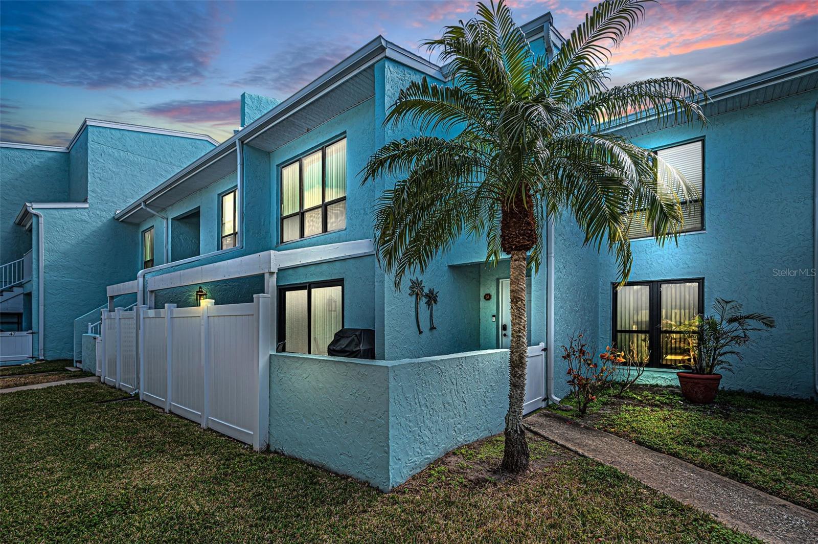 Live the Direct Waterfront Lifestyle in Indian Rocks Beach in this contemporary 2-bedroom, 2.5-bath, two-story residence in the sought-after waterfront community of Windrush Cove delivering an elevated, sun-soaked Beach lifestyle. Perfectly positioned along the serene Intracoastal shoreline with unobstructed waterfront views, this light-filled two level condo offers seamless indoor–outdoor living and a thoughtfully reimagined interior styled in soft coastal hues and a subtle beach-inspired palette.  Enjoy the benefits of a secluded waterfront enclave featuring a resort-style heated pool, clubhouse, fitness area, and more. With over 1,200 square feet of open-concept nautical living, the residence is bathed in natural light and refreshed with a modern coastal design. The spacious layout includes abundant storage, a well-designed split bedroom plan, and a large, pergola covered patio at the entry, all just a short stroll to the beach and moments from everything IRB offers. Step inside to an awe-inspiring main level showcasing an expansive, ultra chic Kitchen, Living, and Dining area with island-inspired tones and an effortless flow to the waterfront patio through brand-new impact sliding glass doors — the perfect setting for tangerine sunrises and sunsets. The fully renovated, coastal-inspired designer kitchen infused with soft, seaside hues feature contemporary navy cabinetry, quartzite countertops, new stainless-steel appliances, and a generous social island ideal for the chef who loves to stay connected. A stylish half bath is conveniently located off the entry.  Upstairs, the large Primary Suite offers a spacious sitting area, two walk-in closets, and a picture window framing the shimmering Community pool and coming sunset!  The Primary suite is complemented by a beautifully updated full bath in a soft shoreline-inspired palette. A second bedroom features an ensuite bath, a generous sized walk-in closet with a stackable washer/dryer nicely tucked away. Additional valued features include fresh interior paint, new craftsman baseboards & doors, an abundance of storage areas & nooks, newer HVAC, one car carport with storage just out front and a cohesive coastal color palette throughout. Pet-friendly with low HOA fees covering roof, exterior maintenance, water, trash, sewer, and master insurance (including flood). Rentals permitted with a 1-month minimum, preserving the community’s boutique feel. Located in the heart of Indian Rocks Beach — a golf-cart-friendly coastal town with parks, playgrounds, a boat ramp, beach access, and vibrant local shops and restaurants, this residence offers effortless access to Tampa, Pinellas County, and nearby airports. Coastal elegance meets modern luxury in this beautifully remodeled waterfront retreat with unobstructed waterfront views —where mornings start with sunshine on the water and evenings end in pure coastal calm. Owner will consider financing the purchase with sufficient downpayment.