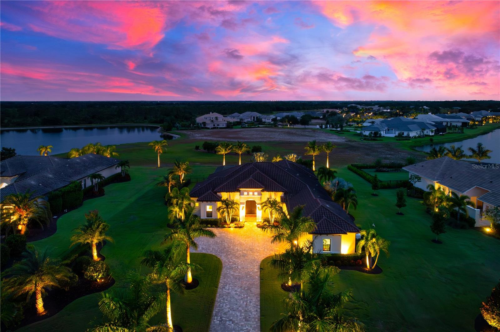 Set amidst 1.15 acres in the exclusive, gated community of The Concession, this custom-built John Cannon home, completed in 2018, offers a lifestyle of unparalleled elegance and comfort. As you arrive, a stately paver driveway framed by royal palms leads you to a three-car side-entry garage, setting the stage for the sophistication within. Inside, 10-foot disappearing glass sliders in the great room create a seamless flow between the indoors and the expansive lanai, where panoramic views of lush landscaping and serene lakes provide the perfect backdrop for unforgettable sunsets. Designed for both relaxation and entertaining, the outdoor oasis features a heated saltwater pool and spa, a gas firepit, and a resort-style kitchen with a high-end grill, sink, and refrigerator.

At the heart of the home is a chef’s kitchen that redefines culinary excellence, boasting Sub-Zero, Wolf, and Bosch appliances, quartz countertops, custom soft-close cabinetry, and a generous kitchen island ideal for gatherings. Adjacent, a bar area with a dual-zone Perlick wine fridge elevates your hosting capabilities. The owner’s suite is a true retreat, featuring dual custom walk-in closets and a spa-inspired bathroom with a freestanding tub, dual vanities, and a glass-enclosed shower with dual showerheads.

Every inch of this home speaks to quality and thoughtful design, with hurricane-rated impact glass, Icynene insulation, a whole-house water softener, and a tankless water heater among its many upgrades. An oversized lot allows for future possibilities, such as a casita or additional garage, ensuring the property can evolve with your vision. Located in The Concession, a community known for its world-class golf course ranked among Florida’s finest and host of the 2021 PGA Workday World Golf Championships, this home is more than a residence—it’s an invitation to live the Florida dream, where sophistication meets serenity. All this is just minutes away from premier shopping, exceptional dining, and scenic bike trails, offering the perfect balance of luxury and convenience.
