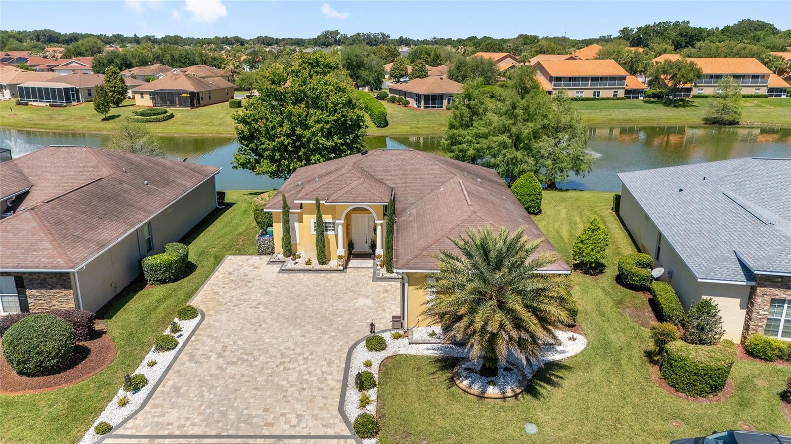 NOW OFFERED WITH A SUBSTANTIAL $50,000+ PRICE REDUCTION — an extraordinary opportunity to secure premier waterfront living at an exceptional value. STUNNING WATERFRONT HOME LOCATED IN A RESORT-STYLE COMMUNITY! This GORGEOUS Ibis model delivers the ultimate Florida lifestyle with a BREATHTAKING WATERFRONT BACKDROP and an outdoor living space that truly steals the show.
 From the moment you arrive, the PAVER DRIVEWAY and ENHANCED LIGHTED LANDSCAPING set the tone for the elegance found throughout this home. Step inside and immediately take in the SERENE WATER VIEWS framed perfectly through the back terrace. The interior is beautifully appointed with CROWN MOLDING, LUXURY VINYL PLANK FLOORS & TILE (No Carpet), TRAY CEILINGS, and an OPEN-CONCEPT layout designed for both comfort and style. The spacious kitchen features a center island, GRANITE COUNTERTOPS, ABUNDANT LIGHTING, and plenty of storage—ideal for everyday living or entertaining. The dining room’s picture window overlooks the patio and pond, creating a peaceful setting for every meal. The primary suite offers a private retreat with a French door leading directly to the Florida room. Two guest bedrooms are thoughtfully positioned on the opposite side of the home, providing comfort and privacy for visitors. The FLORIDA ROOM, WRAPPED IN WINDOWS, showcases PANORAMIC WATER VIEWS and flows seamlessly to the WOW-FACTOR 47'X30' PAVER TERRACE—LIGHTED, and OVERLOOKING water with shimmering fountains. This outdoor space is truly spectacular. Beyond the home itself, the community elevates your lifestyle even further. The HOA includes irrigation, lawn and garden maintenance, and access to a 13,000 sq. ft. clubhouse featuring a fitness center, library, catering kitchen, and event spaces. Enjoy the resort-style pool and spa, putting green, tennis courts, and pickleball courts—all just steps from your door. This is more than a home; it’s a lifestyle. Don’t miss your opportunity to experience this exceptional waterfront property. Water Heater 2025, HVAC 2022, NEW ROOF coming soon.