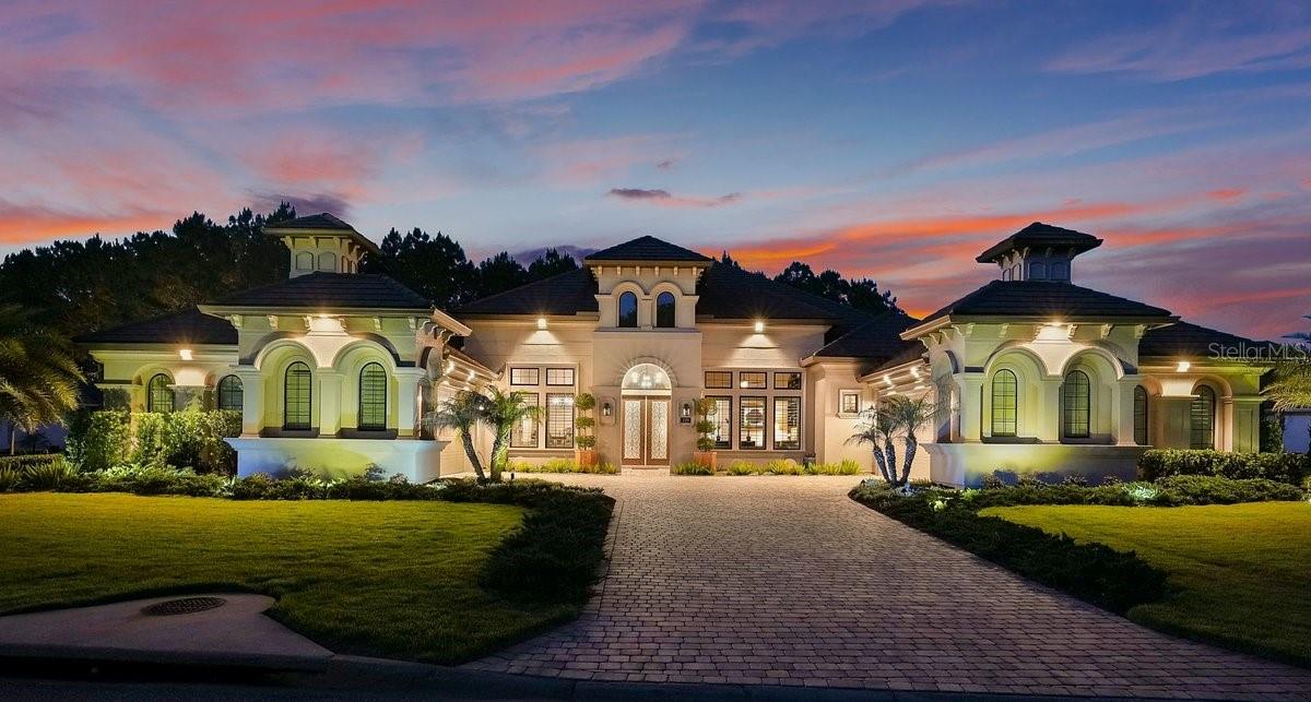 Set on a 0.65-acre homesite, one of the largest homesites in The Conservatory at Hammock Beach, this custom 2023 ICI Homes Monaco enjoys protected preserve views both behind and across the street, creating a rare sense of privacy, openness, and natural beauty. It sets the tone for everything this home delivers. Coffered ceilings define the formal dining room and great room, where 10-foot pocket sliding glass doors dissolve the line between inside and out, opening to a covered screened lanai overlooking a saltwater heated pool and spa. The chef's kitchen is where this home truly earns its place in the luxury market. Crisp white perimeter cabinetry rises to 42-inch uppers, topped with a second tier of glass-front display cabinets lit from within, and under-cabinet lighting illuminates the space throughout.

The gas cooktop sits beneath a custom white wood hood, with double wall ovens on a dedicated built-in just steps away. The oversized island makes its own statement, warm walnut-toned cabinetry below with a built-in microwave drawer, a thick mitered-edge granite slab on top, with a single-bowl sink, dishwasher, and seating for the guests. A walk-in pantry with frosted glass atrium door, butler's pantry or wine bar with its own sink, soft-close doors, oversized drawers, pull-outs, dedicated trash pull, and a whole-house water treatment system round out a kitchen that works as beautifully as it looks.
The primary suite is its own private wing. Dual walk-in closets, a freestanding soaking tub, frameless walk-in shower, separate vanities, and a connected exercise room with direct access to one of the two-car garages. Two secondary bedrooms feature ensuite baths. A third bedroom sits conveniently close to the pool bath, a thoughtful layout that flows naturally for everyday living.
Step outside and the property expands again. The covered screened lanai and separate cabana deliver a full outdoor kitchen with weatherproof cabinetry and granite countertops. The detached guest casita offers a private suite, full bath, walk-in closet, and pre-wiring for surround sound, ready for whatever you envision. Travertine decking and lush preserve views complete an outdoor living experience that feels like a resort you never have to leave.
Soaring 12-foot ceilings and 8-foot interior doors enhance the home's open, airy feel throughout. Designer lighting and a built-in surround sound system serve the main living and kitchen areas, and a whole-house Generac generator with two buried propane tanks ensures this home is as prepared as it is polished. A four-car garage with EV charging and 6,453 total square feet complete the picture.
Behind the guarded gates of Tom Watson's signature 18-hole championship course, with Hammock Beach Resort privileges, ocean access, and the ease of tax-friendly Florida living, this is the one that checks every box. Welcome home!

Square footage received from tax rolls. All information recorded in the MLS is intended to be accurate but cannot be guaranteed.