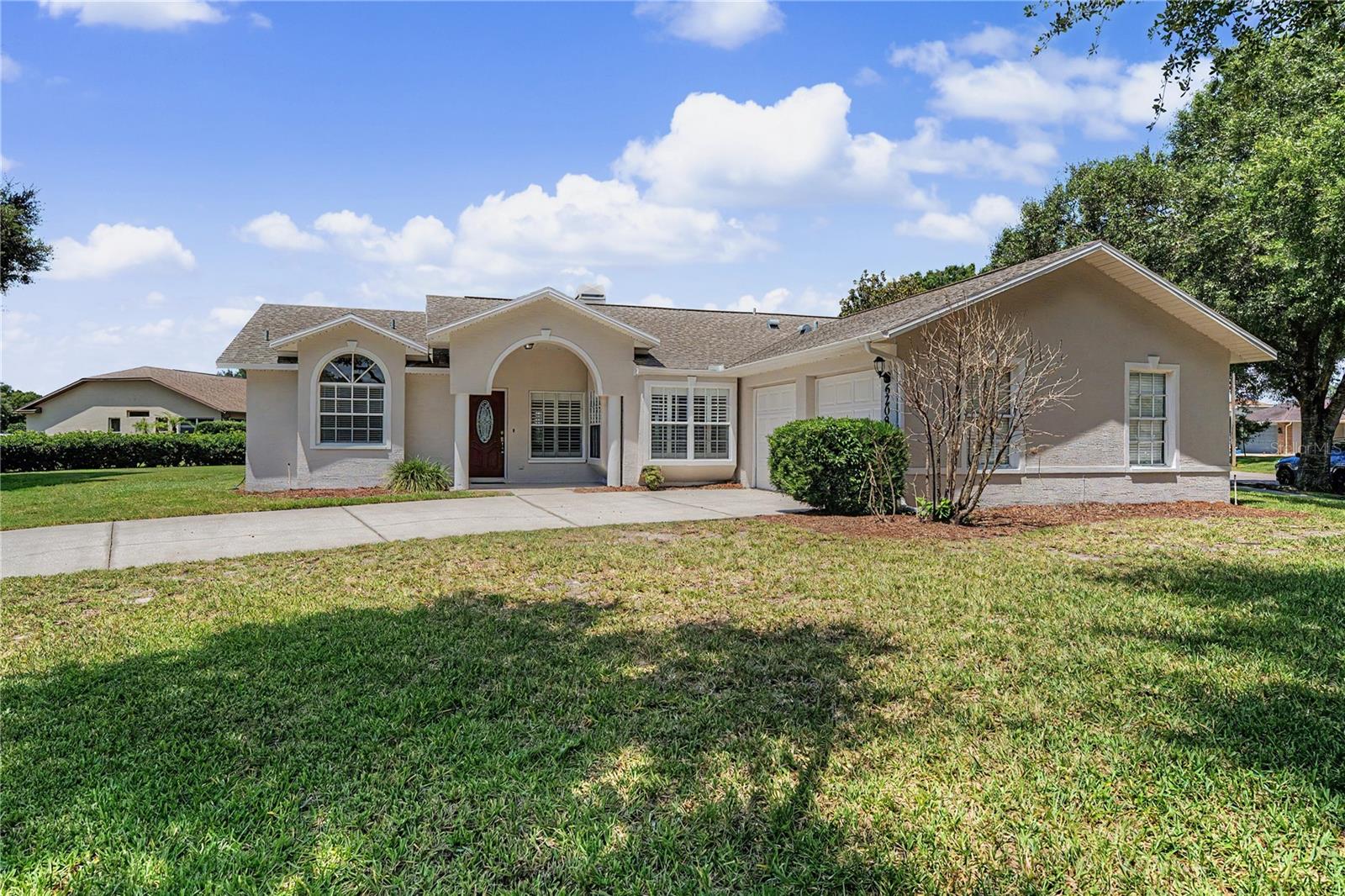 SILVER OAKS, one of Zephyrhills established communities where tree-lined, private streets wind around ponds thru the neighborhood, is Gated in the rear for security and has No CDD fees and Low quarterly HOA fees, features this one owner, custom-built concrete block and stucco residence, freshly renovated and now ready for its next chapter.  Situated on an oversized, landscaped homesite, this light, bright, 3-bedroom, 2-bath, 2-car garage home offers the perfect place to downsize, retire, move-up and transition, or purchase and lease.  Freshly painted inside and out, the home shines with numerous updates including remodeled bathrooms, freshly painted kitchen and laundry room cabinetry, popcorn ceiling removal, and brand-new carpeting in Bedrooms 2 and 3 installed in 2025. Once inside, discover soaring 12-foot cathedral ceilings and an inviting open layout designed for both everyday living and entertaining. The spacious great room features a wood-burning fireplace focal point, creating the perfect gathering space for family and friends. The desirable split-bedroom floor plan provides privacy for everyone, with the owner's suite tucked away on one side, featuring a custom remodeled en-suite bath with stunning wood cabinets, storage tower, soaking tub, water closet and separate shower.  The heart of the home is OPEN from the great room into the breakfast nook and kitchen, while the separate flex areas showcase a convenient wet bar and French doors leading to the outdoor patio—ideal for morning coffee, weekend barbecues, or simply enjoying Florida's beautiful weather. The oversized 21' x 21' attached garage offers plenty of room for vehicles, storage, and hobbies, with both interior and exterior access.  For added peace of mind, this home experienced no flooding or hurricane damage and has been exceptionally maintained throughout its ownership. Opportunities like this are becoming increasingly rare in Silver Oaks, where you enjoy a move in ready home within 1 mile of movie theater, bowling, shopping, YMCA, medical facilities, restaurants and major highways for easy commute to Wesley Chapel, Lakeland, Orlando, Tampa, Ocala, International airports and the Beaches! Combining quality construction, thoughtful updates, an oversized lot, and an unbeatable location, this home is attractively priced and ready for immediate enjoyment. Don't miss your chance to own this outstanding Silver Oaks gem before it's gone! CALL TODAY!