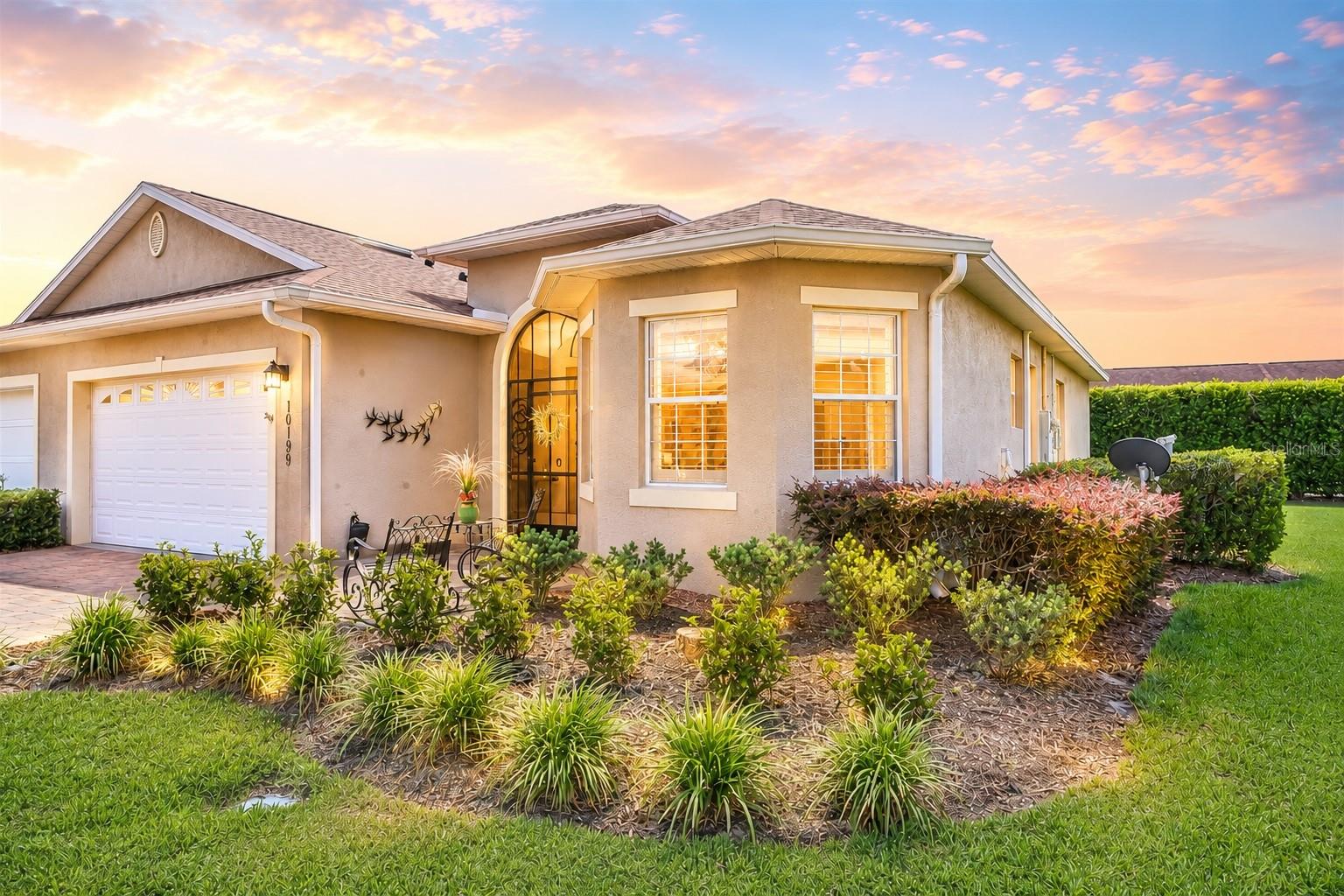 Welcome to the villa that absolutely refuses to be basic. Tucked inside the highly sought-after, gated community of Lakeside Landings, this STUNNINGLY REMODELED home is packed with thoughtful upgrades, designer finishes, and the kind of details buyers fall in love with the second they walk through the door.

From the moment you arrive, the EXPANDED PAVER DRIVEWAY, immaculate landscaping, and charming curb appeal set the tone. Inside, nearly every inch has been elevated — from the LUXURY VINYL PLANK FLOORING throughout and EXQUISITE CROWN MOLDING to the PLANTATION SHUTTERS, DESIGNER LIGHT FIXTURES, and gorgeous 5.5” baseboards that give the home a polished, custom feel.

The kitchen is absolutely charming featuring GRANITE COUNTERTOPS, a stylish tiled backsplash, FARMHOUSE SINK, all NEW APPLIANCES, and designer touches everywhere you look. Even the laundry room got the luxury treatment with NEW CABINETRY, COUNTERS, SINK, plus a NEW WASHER & DRYER.

The upgrades just keep going:
NEWER ROOF (2024), WHOLE-HOUSE SOLAR for impressively low electric bills, HYBRID WATER HEATER, WHOLE-HOUSE WATER FILTRATION SYSTEM, NEW BATHROOM GRANITE COUNTERS, SINKS, FIXTURES, SHOWER ENCLOSURES, DESIGNER FANS, and fresh interior paint throughout.

And then there’s the outdoor living… because Florida living should feel FUN. The massive 10’ x 26’ birdcage is a dream setup with electricity, irrigation, hose bib, and gorgeous EPOXY-COATED flooring that continues through the lanai and garage for a clean, upscale finish. There is even a glimpse of a serene water view. Add in POWER SHADES rated to withstand winds up to 80 MPH, SUSPENDED GARAGE STORAGE, custom shelving and cabinetry, and you’ve got a home that is as functional as it is beautiful. FRESH EXTERIOR PAINT coming soon!

But possibly the cutest feature of all? A dedicated little ASTROTURF PET AREA complete with its own MINI FIRE HYDRANT for your furry best friend. Honestly… iconic.

And the LIFESTYLE? Absolutely unmatched. Lakeside Landings offers resort-style amenities including a sparkling pool with waterfalls and fountains, a second satellite pool, jacuzzi, fitness center, pickleball and tennis courts, billiards room, library, card room, basketball court, playground, two dog parks, and access to Lake Miona for fishing and kayaking. Even better — you’re just a quick golf cart ride from The Villages, where nightly entertainment, dining, shopping, and dancing await. NO CDD & NO BOND!!!!

This home is MOVE-IN READY and just feels special from the moment you step inside. Call today to set up your private showing and see for yourself! :-)