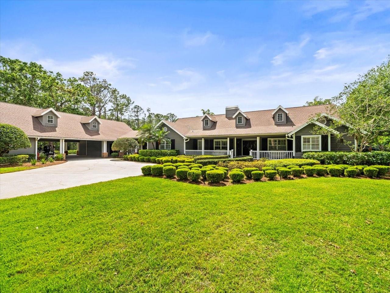 This is an exceptional five-acre gated estate with a relaxing country atmosphere…surrounded by other outstanding private estates. From the gated brick entrance, you will enjoy a long private drive back to a beautiful home with many wonderful features. This home has four spacious bedrooms and 4 bathrooms, providing ample space for family and guests. It also boasts a nice open floor plan, beautiful wood floors and plantation shutters adorning windows that invite in lots of natural light. A large upstairs playroom offers endless possibilities for recreation and relaxation.

As you step outside, you are greeted by expansive landscaping featuring beautiful grandfather oaks and a fish pond. Whether you’re hosting family gatherings or seeking a peaceful retreat, the outdoor amenities are second to none. Enjoy leisurely afternoons by the pool and the advantages offered by the separate building serving as a recreational area, pool bath and outdoor kitchen. For sports enthusiasts, a private tennis court awaits, offering a backdrop of lush greenery and privacy.

Additional features include an air-conditioned man cave/barn, and a practical storage room and RV/boat storage to keep your belongings perfectly organized. Also, in addition to the attached 3 car. garage there is a detached 6 car garage. Equestrian enthusiasts will find much to love, with useable equestrian-friendly acres and the proximity of the Brooker Creek riding trails. Young ones and families can explore and create memories in the three-story tree house, adding a touch of adventure to everyday living. Beyond personal recreation, the spacious pasture area accommodates horses and other livestock. Truly one-of- a-kind property located just minutes from the Tarpon Springs sponge docks, access to the gulf and many restaurants with great views of the Gulf of Mexico. Must see to fully appreciate this unique offering!