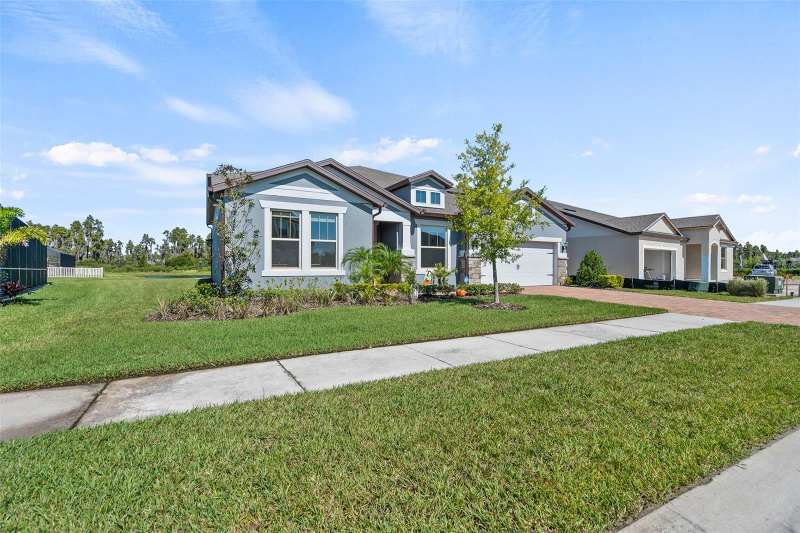 Luxury meets functionality in this stunning executive home located in the gated community of K-Bar Ranch. This highly upgraded Pulte Dockside Grand features 6 bedrooms, 3.5 baths, a tandem 3-car garage, and a spacious open-concept design.  The versatile floor plan includes a first-floor owner's suite with an oversized walk-in closet, two front rooms ideal for home offices, an additional downstairs bedroom, and beautifully appointed bathrooms with designer finishes. The gourmet kitchen showcases a massive quartz island, walk-in pantry, and overlooks the spacious family room with custom brick accent walls, a fireplace, and upgraded lighting.

Pocket sliding glass doors open to an incredible screened lanai featuring travertine flooring, artificial turf, a built-in outdoor kitchen, oversized fans, and panoramic pond views, perfect for entertaining or relaxing. Upstairs offers two additional bedrooms, a full bath, an oversized loft, and a dedicated media room. Thoughtfully upgraded throughout, this one-of-a-kind home offers luxury, comfort, and exceptional indoor-outdoor living. Don't miss your opportunity to make it yours!