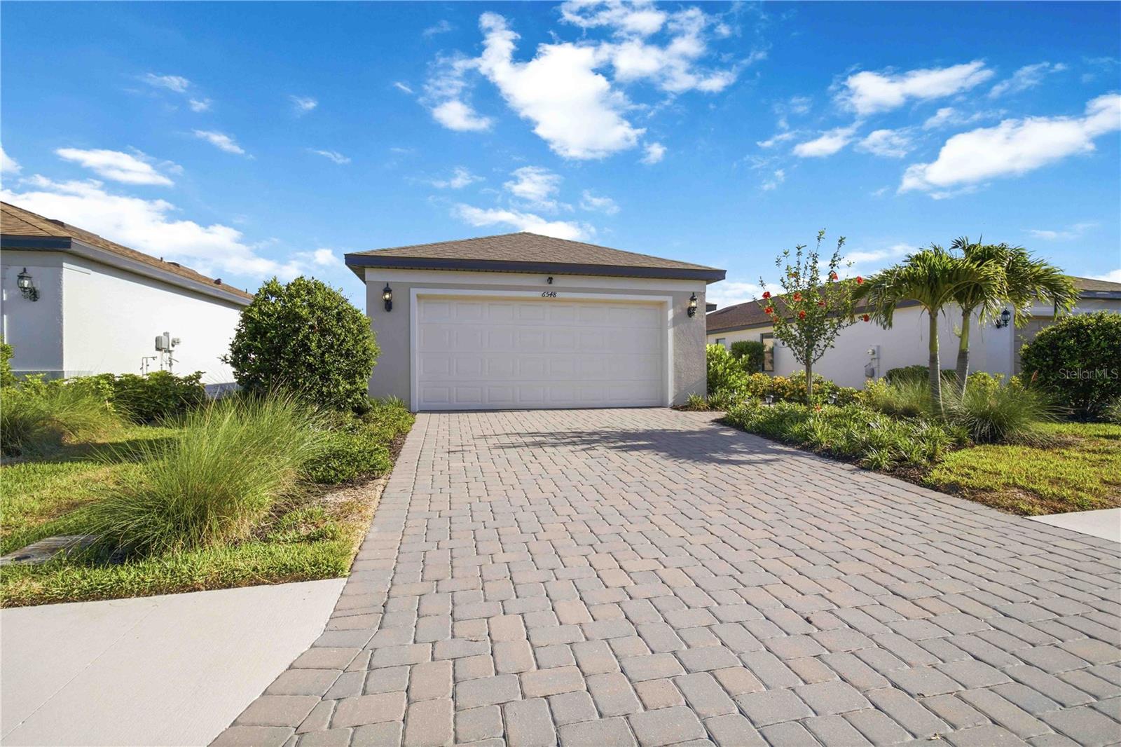 Welcome to Avanti at Waterside, one of Lakewood Ranch's newest and most desirable communities! This beautifully maintained Beachwood floor plan by Pulte Homes is only 2 years old and offers 3 bedrooms, 2 bathrooms, a 2-car garage, and 1,256 square feet of thoughtfully designed living space. The open-concept layout features a bright kitchen overlooking the great room and dining area, creating the perfect space for everyday living and entertaining.  Step outside to enjoy one of this home's standout features—a spectacular, oversized lake view that provides a peaceful backdrop for morning coffee or evening relaxation. With no rear neighbors beyond the water, you'll appreciate the added privacy and tranquil setting.  Located just minutes from Waterside Place, residents enjoy convenient access to waterfront dining, shopping, entertainment, parks, walking trails, and all that Lakewood Ranch has to offer. Avanti offers a low-maintenance lifestyle in a prime location with easy access to I-75, UTC Mall, downtown Sarasota, and the area's world-famous Gulf beaches.