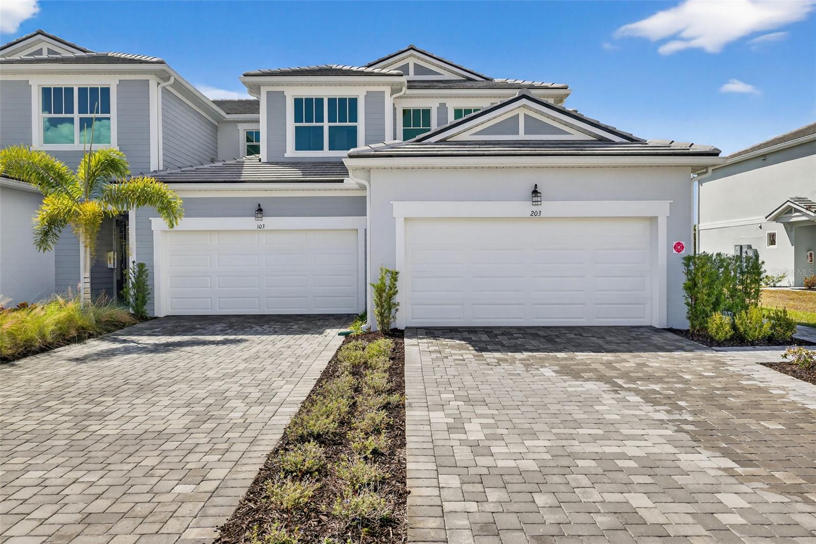 Welcome to this beautifully enhanced Oceangrove II coach home, the most spacious design in the collection and offering 2 bedrooms, 2 bathrooms, a versatile study, and a 2-car garage within an inviting, light-filled layout. A private interior staircase leads to the open main living level, where soft white shaker cabinetry pairs with soapstone-inspired quartz countertops, a striking linear-pattern backsplash, and a large island with seating for five. The executive kitchen also features a cooktop with a sleek vent hood and a built-in wall oven and microwave, flowing effortlessly into the dining area and airy great room. Just beyond, a covered balcony provides the perfect spot to enjoy fresh breezes and quiet moments above the tree line. The serene primary suite includes a large walk-in closet, tray ceiling, and a spa-styled primary bathroom with dual sinks, full-height tile, and a beautifully finished shower. The dedicated study—complete with a closet—offers flexibility for a home office, hobby space, or additional guest room, while the second bedroom and full bathroom ensure comfort and privacy for visitors. Thoughtful details such as 8-foot interior doors, upgraded trim, a convenient laundry room, and a screened entry patio elevate everyday ease. Residents enjoy a vibrant array of community amenities, including a resort-style pool, shaded cabana seating, a fire-pit lounge, and inviting indoor-outdoor gathering spaces perfect for socializing. Walking paths, a dog park, a playground, and an event lawn create even more opportunities for outdoor enjoyment—all just minutes from a nearby waterfront dining district, weekly events, markets, and sun-soaked Gulf-coast beaches, offering a lifestyle that feels both relaxed and refreshingly connected.
***Photos, renderings and plans are for illustrative purposes only and should never be relied upon and may vary from the actual home. Pricing, dimensions and features can change at any time without notice or obligation. The photos may be from a furnished model home and not the home offered for sale.