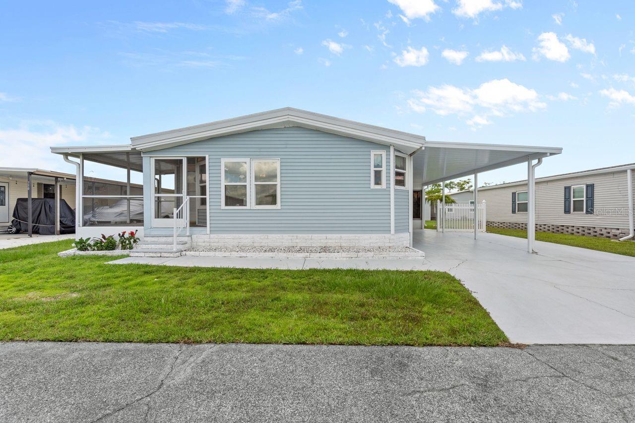 One or more photo(s) has been virtually staged. PRICE REDUCED! Motivated sellers say BRING OFFERS! Spacious SW Florida Getaway in a 55+ WATERFRONT COMMUNITY with GULF access! This affordable 2-bedroom, 2-bath home offers approx. 1,400 SQ. FT. of bright, open living space in Harbor Cove where you can rent a BOAT SLIP for only $100 PER YEAR. New exterior plywood, vinyl siding and roof was resealed in 2024, new AC in 2018 and re-plumbed in 2012. This property features plentiful storage both inside and out, cathedral ceilings, a generous kitchen with room for all your kitchen gadgets and never-ending countertop prep space. Enjoy morning beverages in the bright breakfast nook adorned with windows and evening sunsets from one of your TWO screened and covered lanais. The open-concept living/dining area creates a welcoming space for entertaining plenty of guests. The huge primary suite has a walk-in closet and a large ensuite bathroom with garden tub and separate shower. There is a guest room near the hall bathroom and a separate room with a convenient built-in desk and interior washer/dryer hookups. Outside is an oversized driveway plus two storage areas.  Harbor Cove is a boater’s paradise with a 90-slip marina and two-story activity center in which dances, bingo, card games, trivia, holiday parties, patio picnics and more are held. Residents enjoy two heated pools, a hot tub, tennis and pickle ball courts, shuffleboard, bocce, and a fitness center all for only $150 PER MONTH HOA fee. Partake in water aerobics, pool volleyball, art/craft classes, woodworking, and more. Boating and fishing opportunity are endless here and the community borders the beautiful Myakka River benefitting from the sights and sounds of nature and wildlife. Nearby are restaurants, retail shops, quality medical services, farmers’ markets, spring training baseball, area beaches and a short drive to I-75 for easy airport runs when guests come to visit. With some repairs and creative updates, this roomy home could be transformed into an incredible Florida retreat—offering tons of potential at a price that leaves room to make it your own. Sellers have never occupied the home; it is being sold AS-IS. Schedule a private showing today!