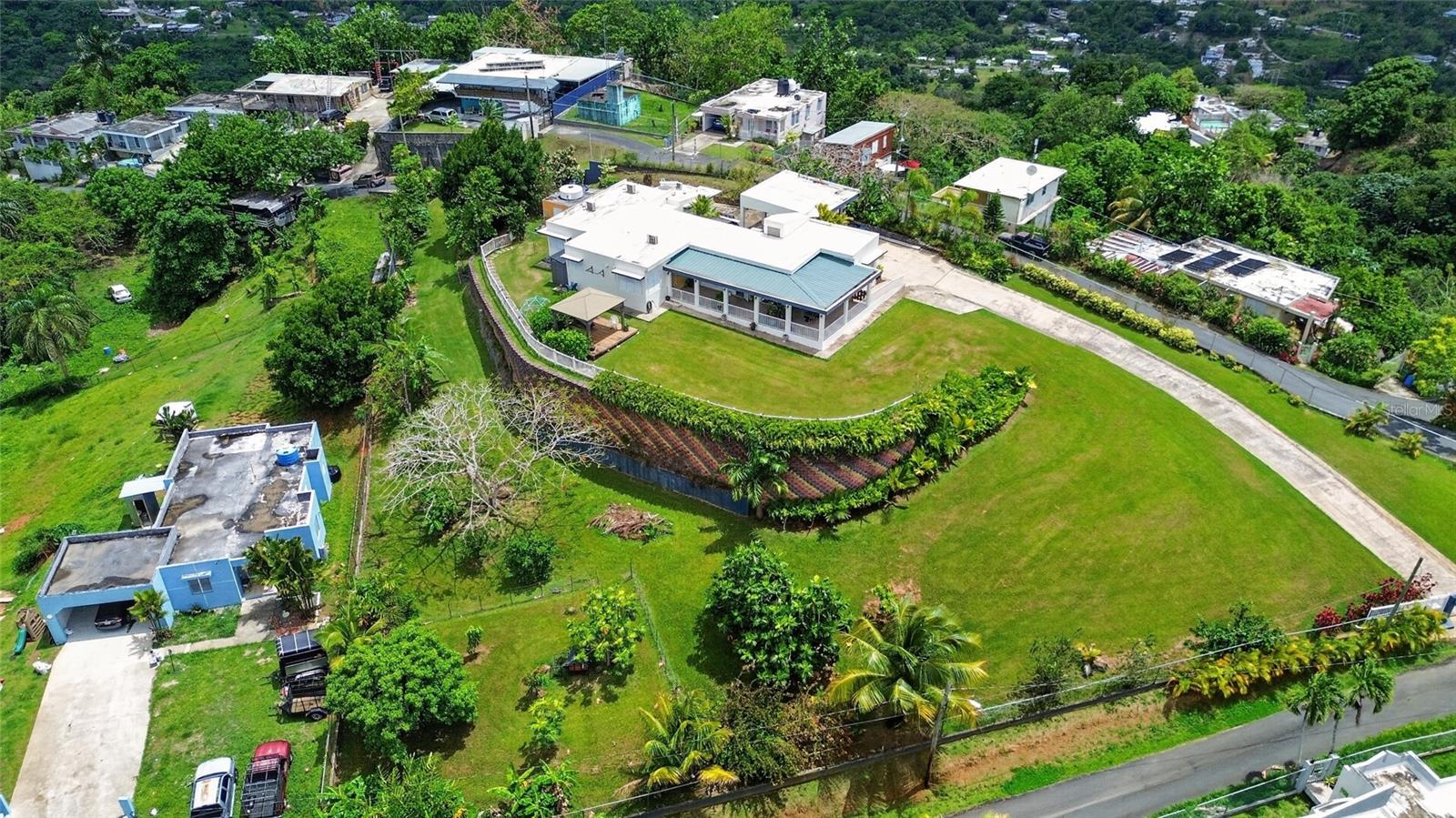 Perched at the top of a hill in Guaynabo, this residence offers incredible views, refreshing breezes, and abundant natural light throughout.

Set on an expansive 1-acre lot, the property combines privacy, space, and everyday comfort, delivering the feel of a country retreat just minutes from the city. Located only 7 minutes from the expressway, it offers convenient access while maintaining a peaceful, private setting.

Designed for resilient living, the home is equipped with a generator, providing added peace of mind and energy reliability. It also features a two-car garage, a gazebo ideal for outdoor entertaining, and a playground area, creating a comfortable environment for both family living and gatherings.
With its elevated position, generous lot, natural surroundings, and strong energy resilience, this Guaynabo hilltop residence offers a rare blend of privacy, views, convenience, and practicality.
