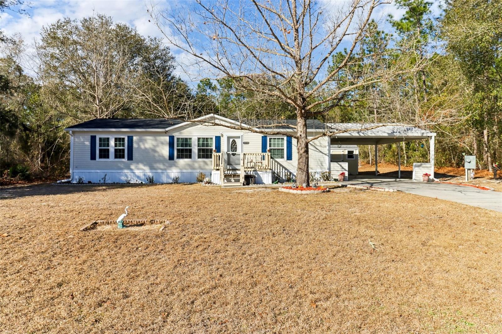Welcome to this charming 3-bedroom, 2-bathroom manufactured home in the serene Forest Green community of Silver Springs, Florida. Boasting 1,296 square feet of thoughtfully designed living space, this home offers comfort, style, and privacy. Step inside to vaulted ceilings in the living room that flow seamlessly into the bright and airy kitchen and dining area. The kitchen is a chef’s delight, featuring a center island, ample cabinets, and generous counter space, all illuminated by abundant natural light streaming through multiple windows. The home also features double-hung windows with a lifetime replacement warranty, adding both value and peace of mind. The primary bedroom offers a peaceful retreat with an en suite bathroom complete with dual sinks and a walk-in shower, while the split floorplan provides privacy for family or guests. Two additional bedrooms share a well-appointed full bathroom. Outside, enjoy a screened-in covered lanai overlooking a spacious backyard surrounded by mature trees, providing a tranquil and private setting. The property also includes a shed and a covered 2-car carport. Sitting on just under a quarter-acre lot, this home combines space and privacy effortlessly. Recent upgrades include a new roof and AC pipes, ensuring peace of mind for years to come. The community offers an HOA that covers water, simplifying maintenance and enhancing convenience. Located close to grocery stores, restaurants, and with easy access to major highways, this home offers both a peaceful retreat and everyday convenience. Experience the perfect blend of comfort, functionality, and Florida charm in Forest Green. Mortgage savings may be available for buyers of this listing.