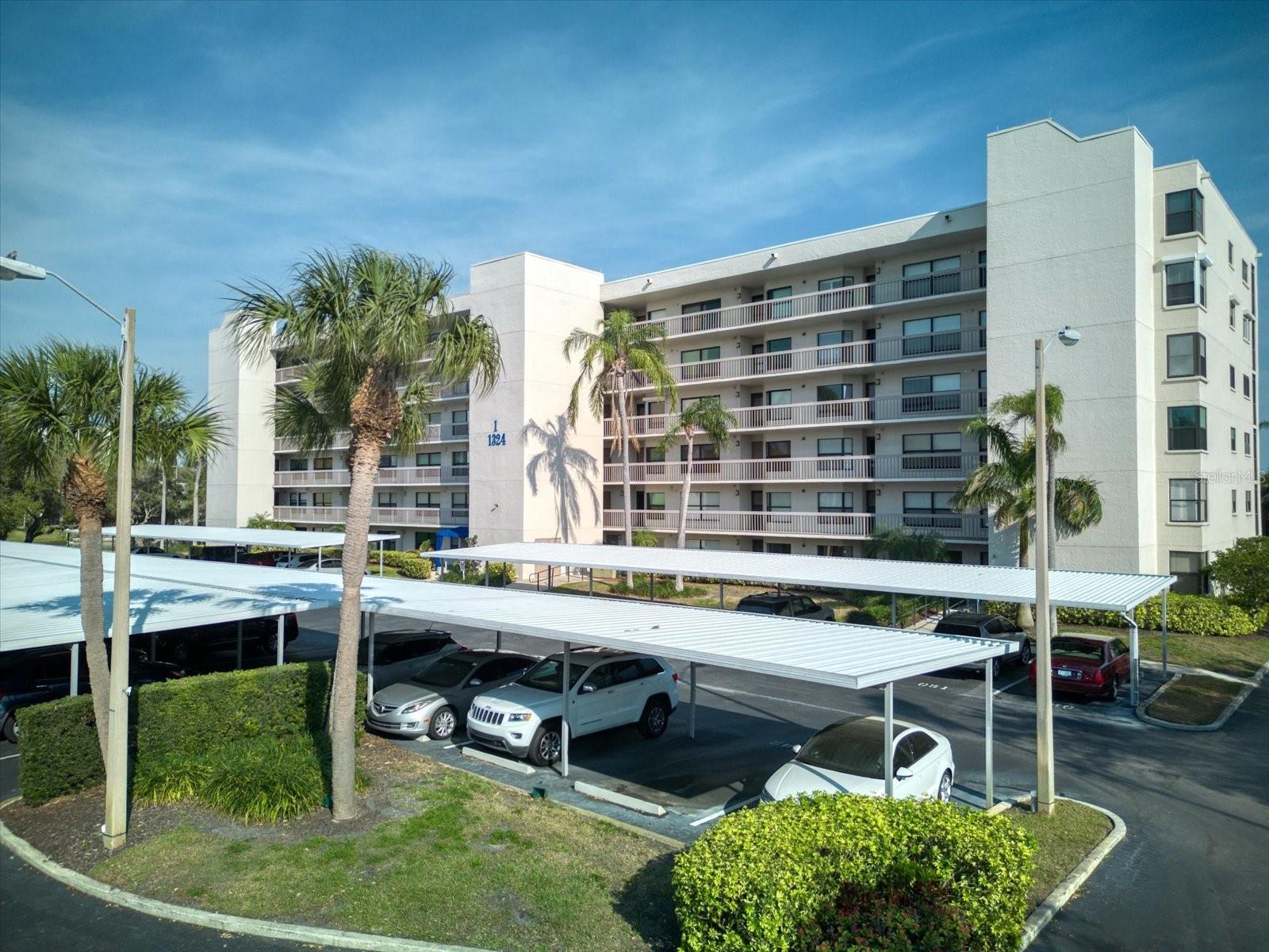 Welcome to Pasadena Cove, a gated, all-age, pet-friendly waterfront community in the heart of South Pasadena. Ideally located just minutes from the white sandy beaches of St. Pete Beach, the vibrant waterfront district of Gulfport, and downtown St. Petersburg, this beautifully maintained community offers the perfect Florida lifestyle. This move-in-ready corner unit features 2 bedrooms, 2 bathrooms, and approximately 1,250 square feet of thoughtfully designed living space with an open floor plan and abundant natural light. Enjoy tranquil pond and fountain views from your private balcony, creating a peaceful tropical retreat right outside your door. The spacious primary suite offers direct balcony access, a walk-in closet, and a private en-suite bathroom, making it the perfect place to enjoy your morning coffee or unwind at the end of the day. Both bedrooms are equipped with hurricane shutters for added peace of mind, and the convenience of an in-unit laundry room makes everyday living effortless. Covered parking is located just steps from the unit, and the nearby SunRunner transit line provides easy access to beaches, dining, shopping, and entertainment. Residents of Pasadena Cove enjoy an impressive array of resort-style amenities, including a sparkling pool and spa, fitness center, billiards room, clubhouse with an updated kitchen and gathering space, and beautifully landscaped grounds. Follow the walking paths to the community marina overlooking Boca Ciega Bay, where boat slips may be available for purchase or lease. Additional community features include RV parking, a car wash station, and an air pump area. Whether you're searching for a year-round residence, seasonal getaway, or tropical retreat, this exceptional property offers comfort, convenience, and the very best of Florida living. Schedule your private showing today.