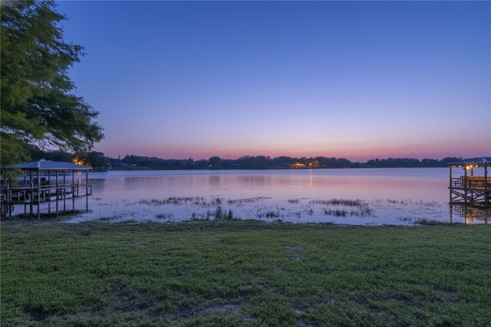 Don't miss this rare opportunity to own one of the last remaining buildable lakefront lots on the highly sought-after East Crooked Lake, a 153-acre private, spring-fed lake. This 0.54-acre parcel offers 100 feet of direct lake frontage - no roads to cross. This is one of the last remaining vacant lots on East Crooked Lake, where your backyard truly meets the water. The land is ready for your dream home, with ample space for a custom build, outdoor living and entertaining, and even space for a pool! Plus, there are no city taxes to pay here!!! Spend your days immersed in lake life, from swimming, paddleboarding, fishing, skiing, and boating right from your private shoreline. As evening falls, unwind while taking in breathtaking year-round sunsets. Located just minutes from US-441, you'll enjoy quick access to everyday conveniences, including dining, shopping, and charming downtowns like Mount Dora and Eustis. This is a vacant land listing. Any home images included in this listing are conceptual renderings only and do not represent an existing structure. Buyer to verify all building responsibilities.